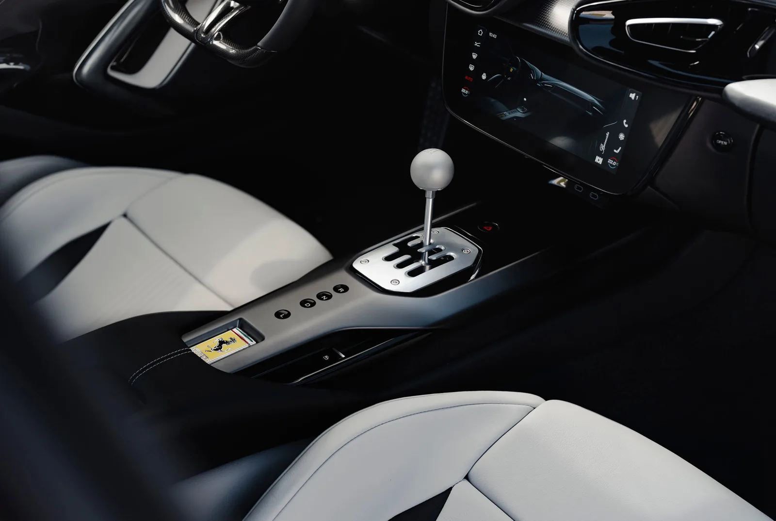 Ferrari 12Cilindri Manuale center console with brushed metal gated shifter and prancing horse plaque on carbon trim