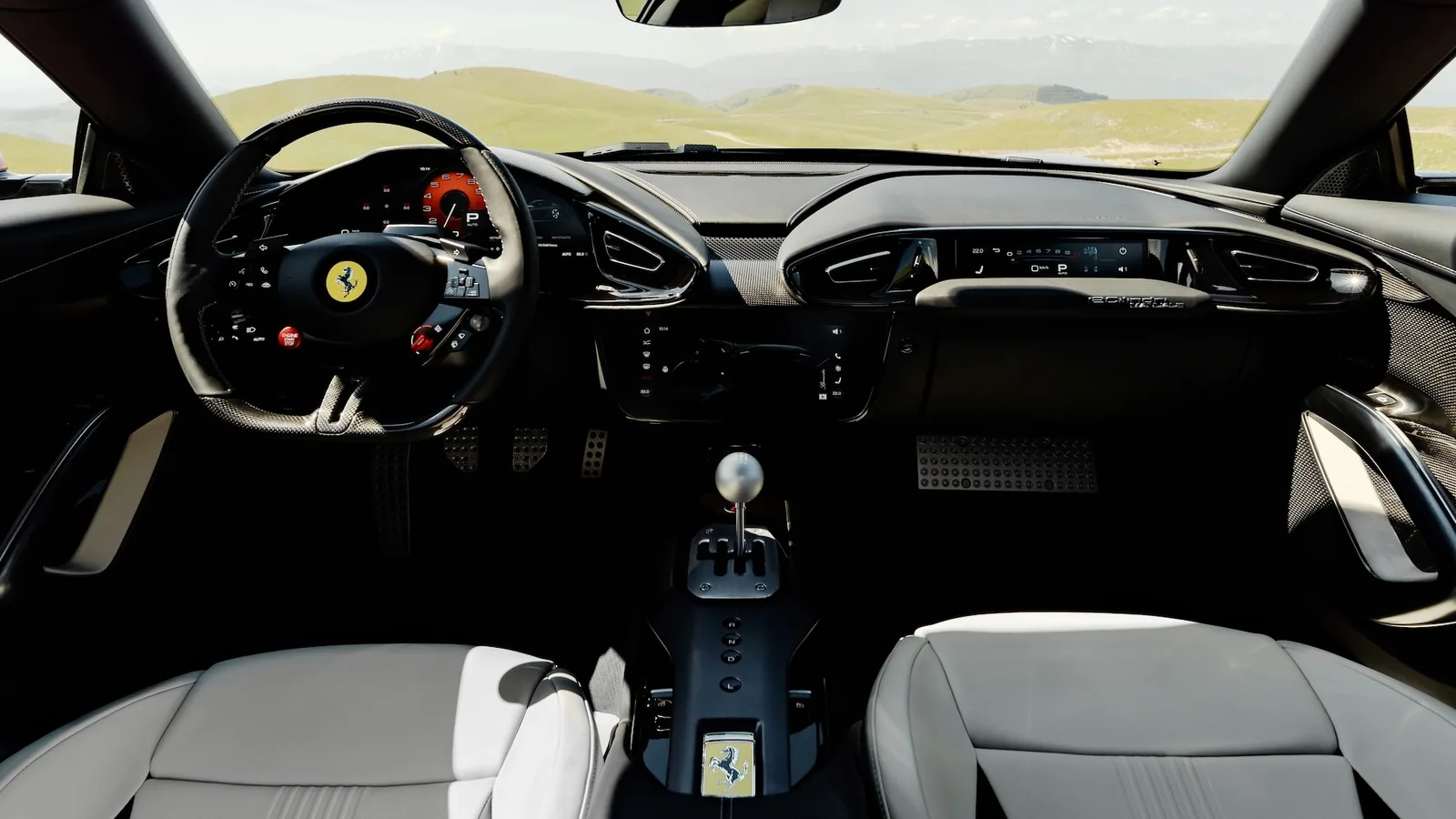 Ferrari 12Cilindri Manuale dashboard panoramic view — steering wheel, digital cluster, passenger display and gated shifter