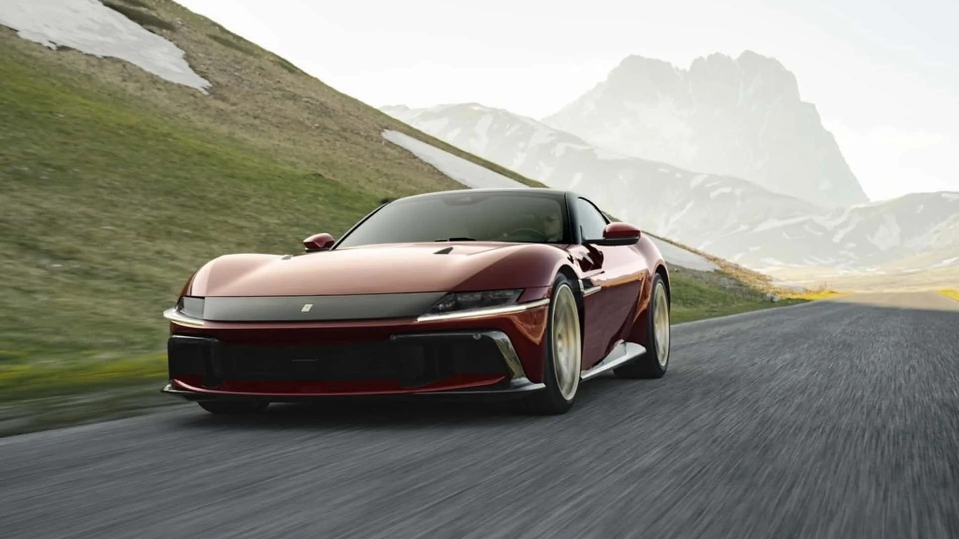 Ferrari 12Cilindri Manuale front three-quarter driving — 830 HP naturally aspirated V12 grand tourer in Rosso Rubino with gold five-spoke wheels