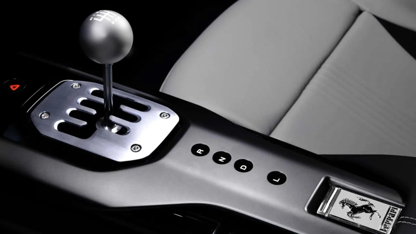 Ferrari 12Cilindri Manuale center console detail — gated shifter next to R N D L drive-mode buttons and Ferrari prancing horse plaque