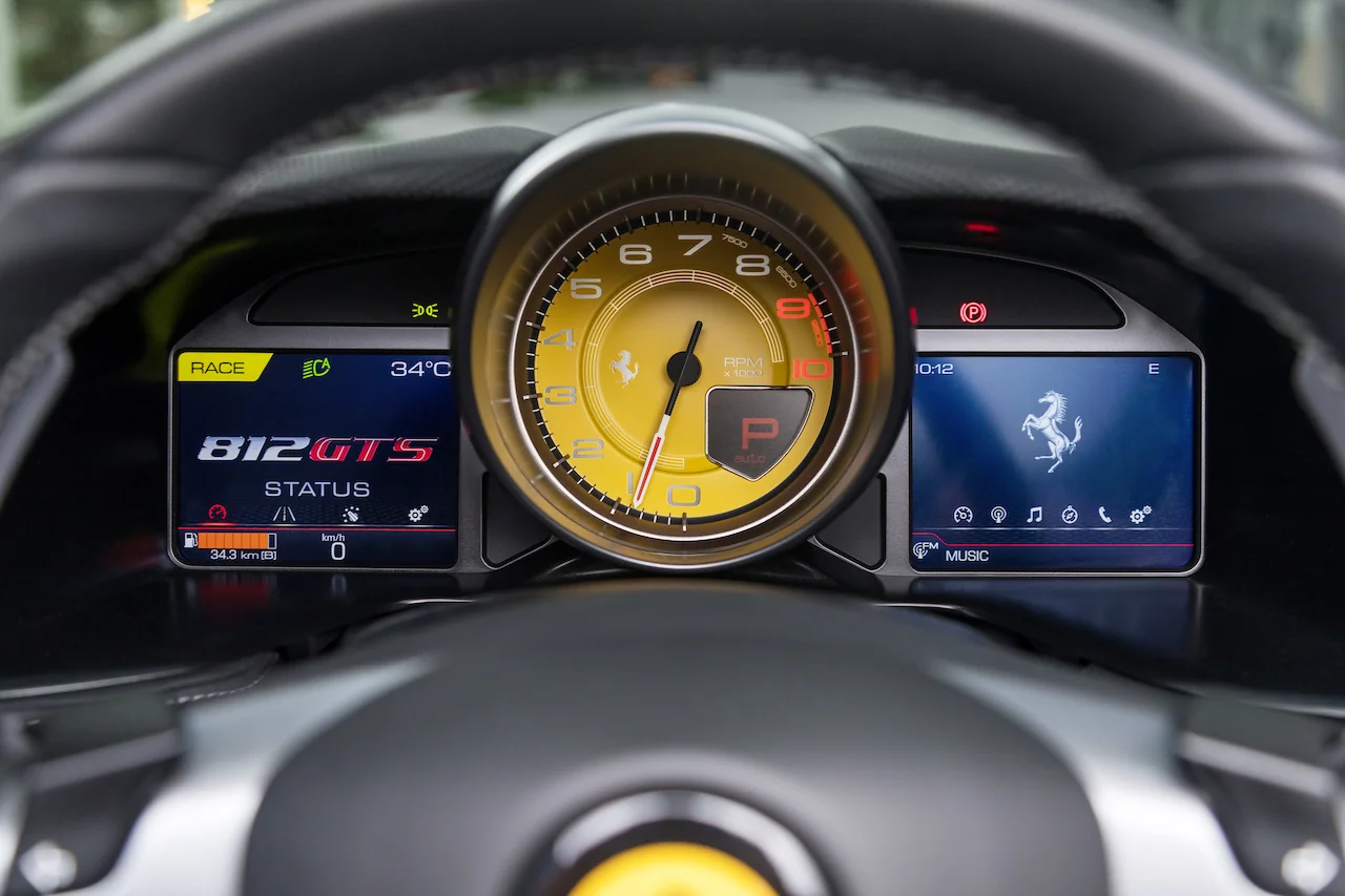 Ferrari 812 GTS yellow analog tachometer and digital display showing 812 GTS status screen