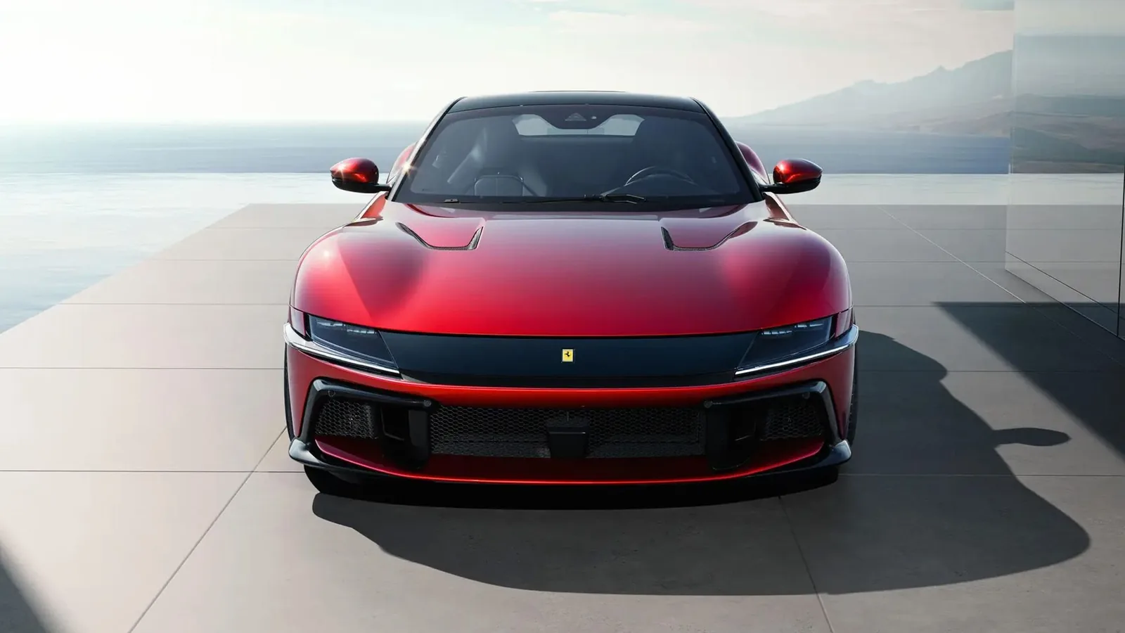 Red Ferrari 12Cilindri front view showing the signature full-width black visor