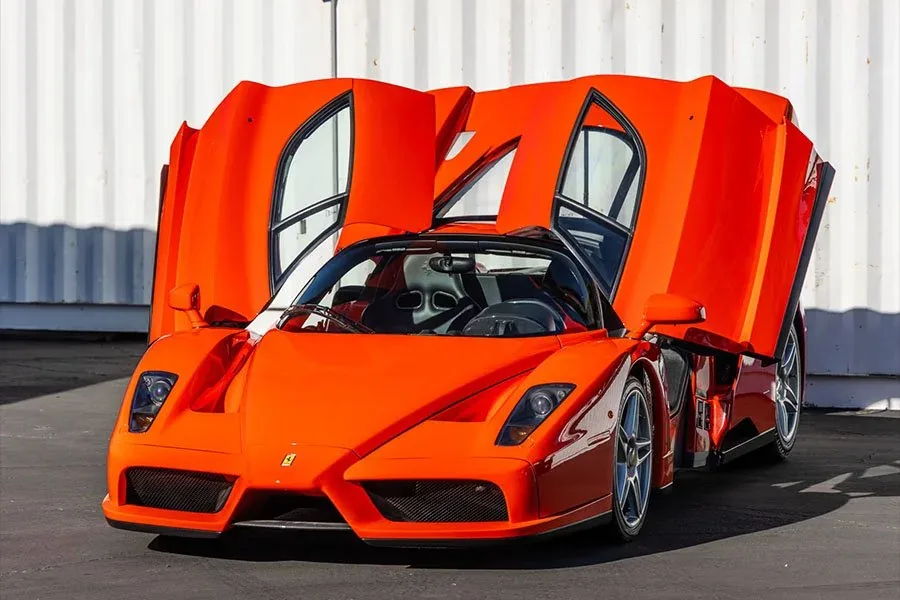 Ferrari Enzo Rosso Dino interior with Nero black trim, carbon-fiber dashboard, red start button and F1-style steering wheel