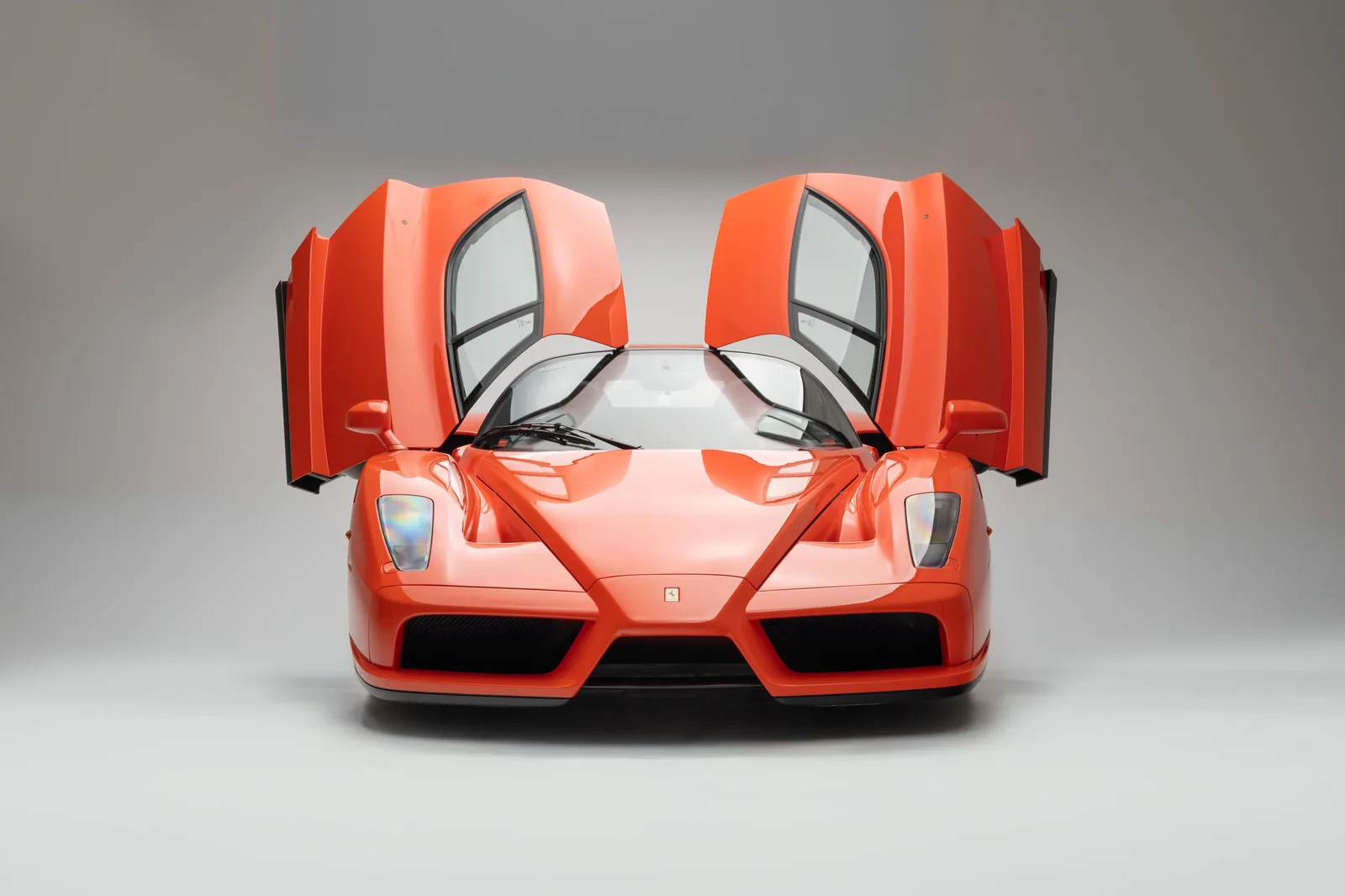 Ferrari Enzo Rosso Dino side profile showing the dramatic wedge silhouette, butterfly door and Ken Okuyama Pininfarina styling
