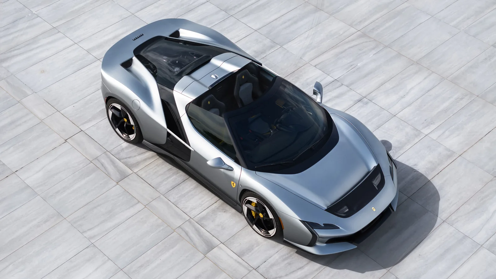 Ferrari HC25 top-down front view in Matte Moonlight Grey — clean sculpted front clamshell, the windshield wrap-around and the open targa cabin