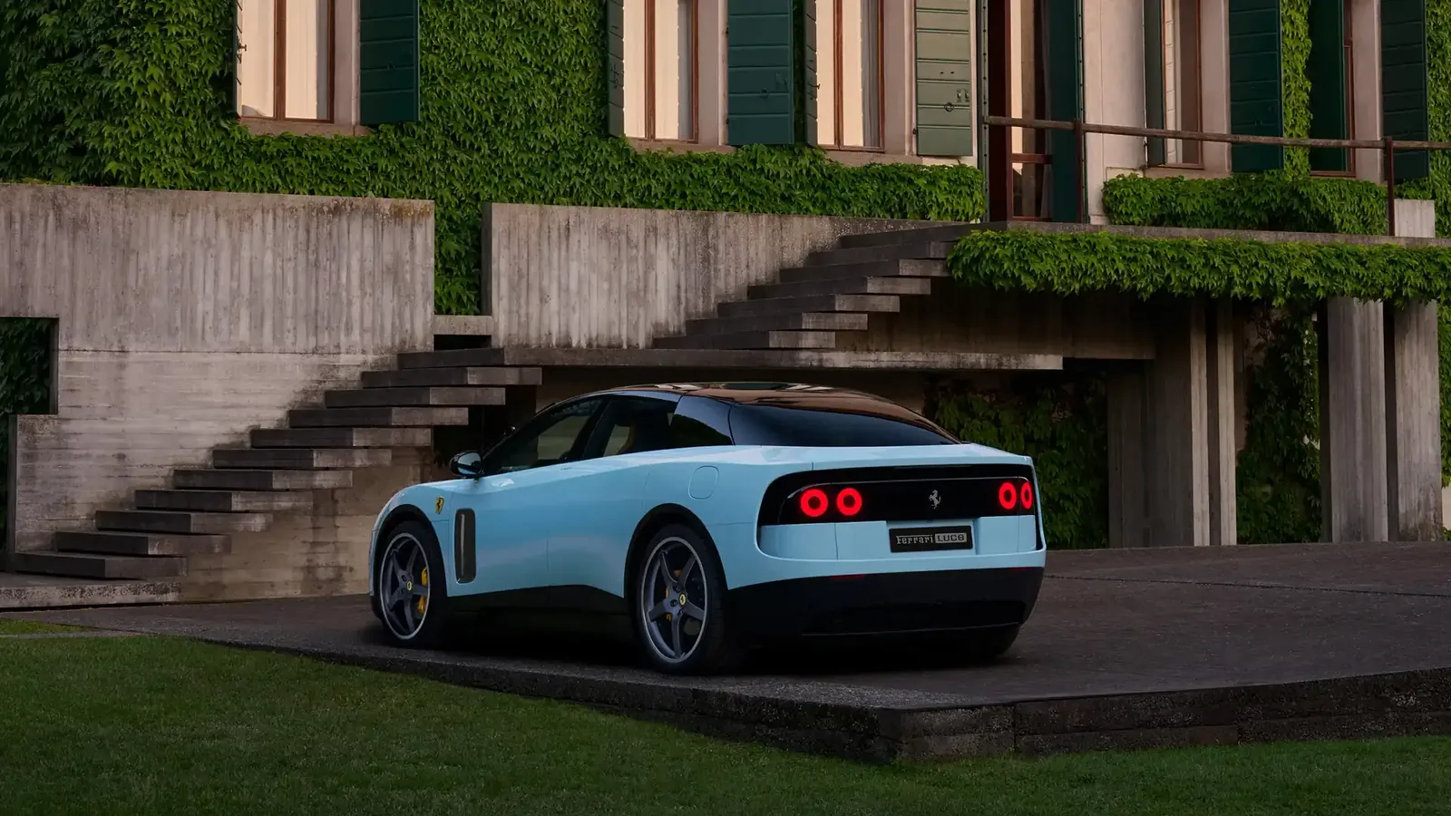 Ferrari Luce rear three-quarter dynamic shot — the controversial 2027 first-ever fully electric Ferrari designed by Jony Ive's LoveFrom studio with 1035 horsepower and 530 km WLTP range, priced at 550000 euros