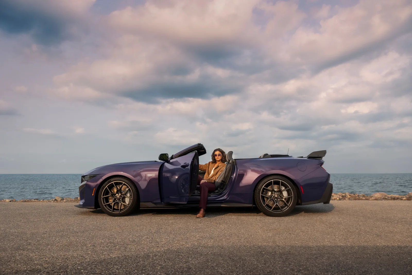2027 Ford Mustang Dark Horse SC Convertible side profile static with driver door open showing interior layout, roof lowered, Precision Purple paint
