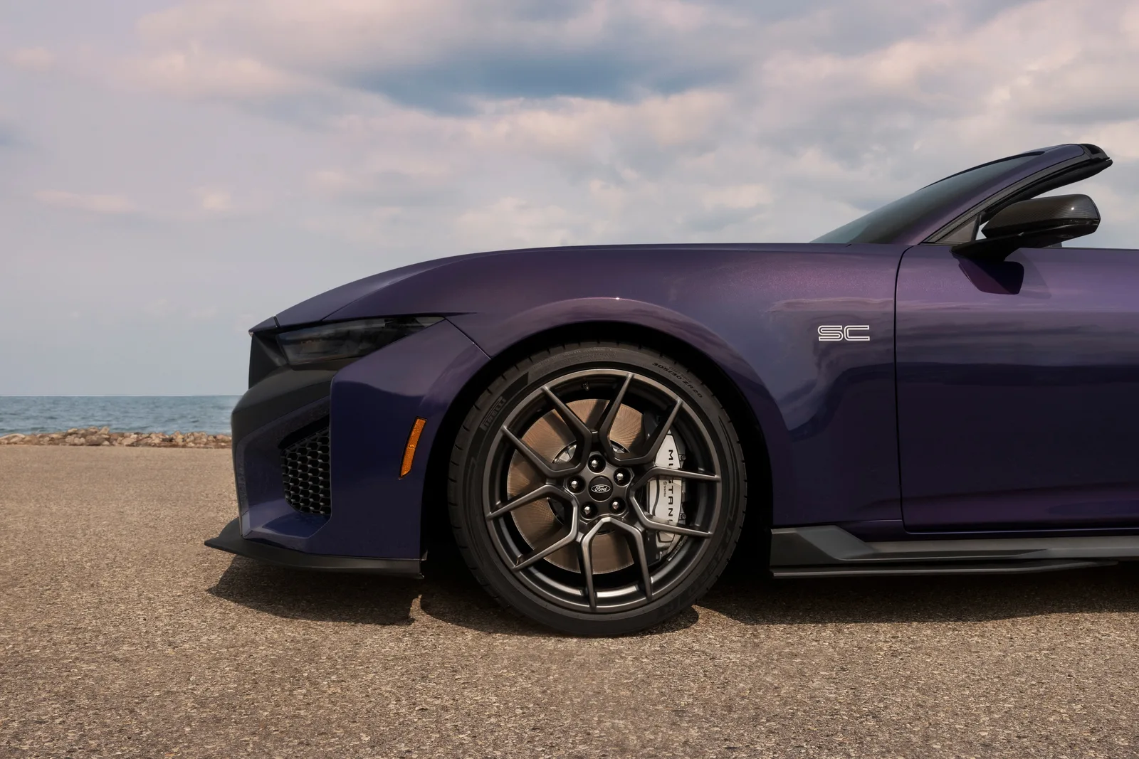 Close-up of the front fender SC badge and gloss-black forged wheel on the 2027 Ford Mustang Dark Horse SC Convertible in Precision Purple