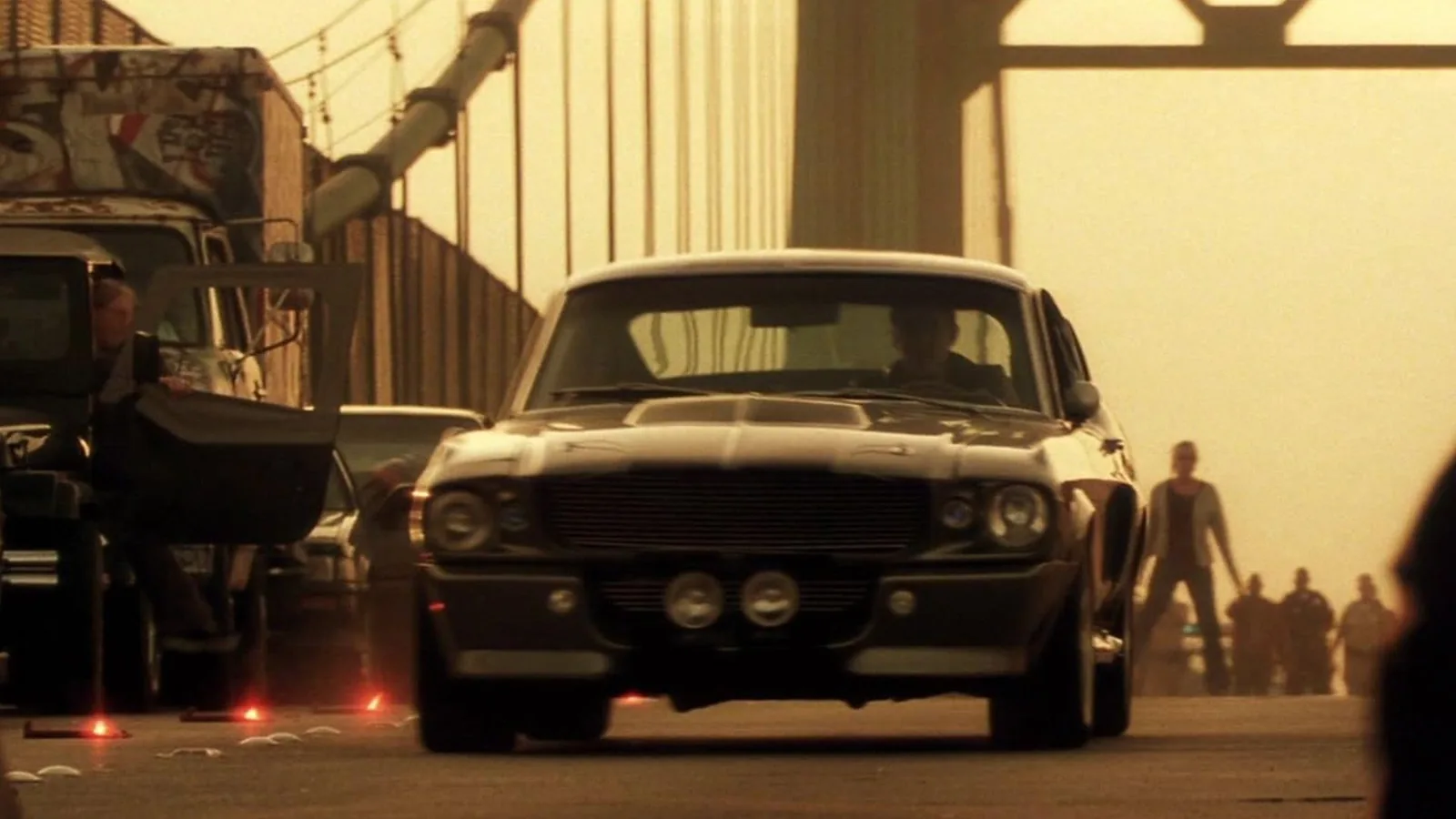 Ford Mustang Eleanor front head-on at the Long Beach Vincent Thomas Bridge chase in Gone in 60 Seconds 2000, pepper-grey Shelby GT500 tribute with dust and container trucks