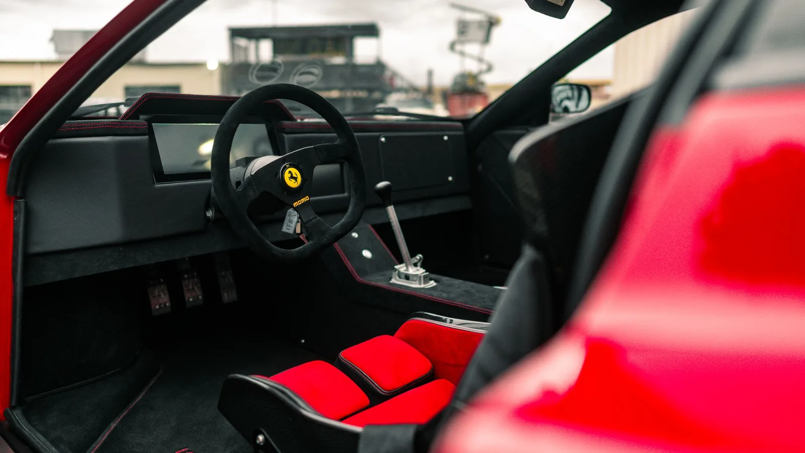 Gas Monkey Ferrari F6 stripped F40-style interior with three-spoke Momo steering wheel, exposed shifter and Recaro bucket seats