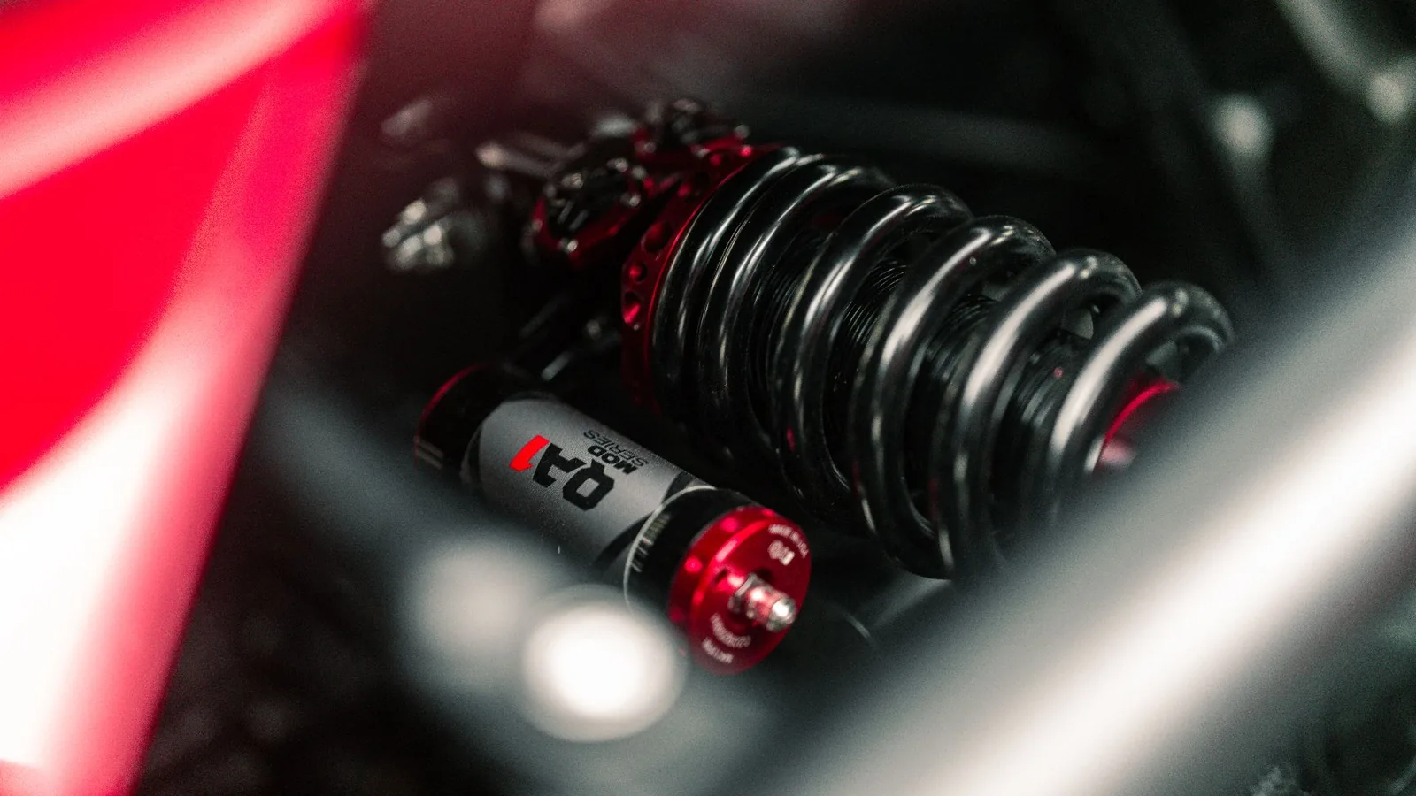 Gas Monkey Ferrari F6 coilover suspension detail with red-anodized adjuster