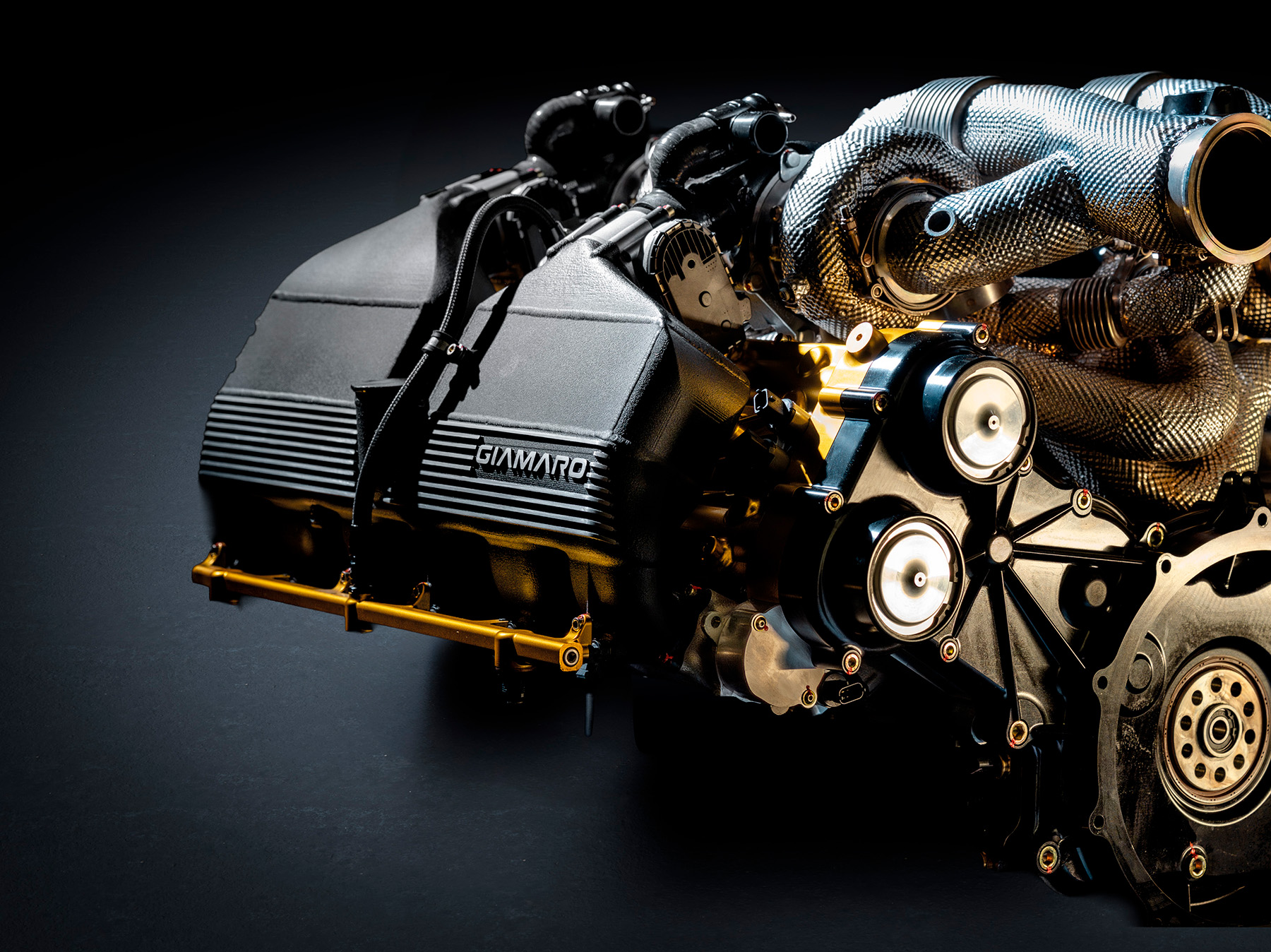 Giamaro Krafla engine bay side detail showing GIAMARO branding and V12 quad-turbo installation