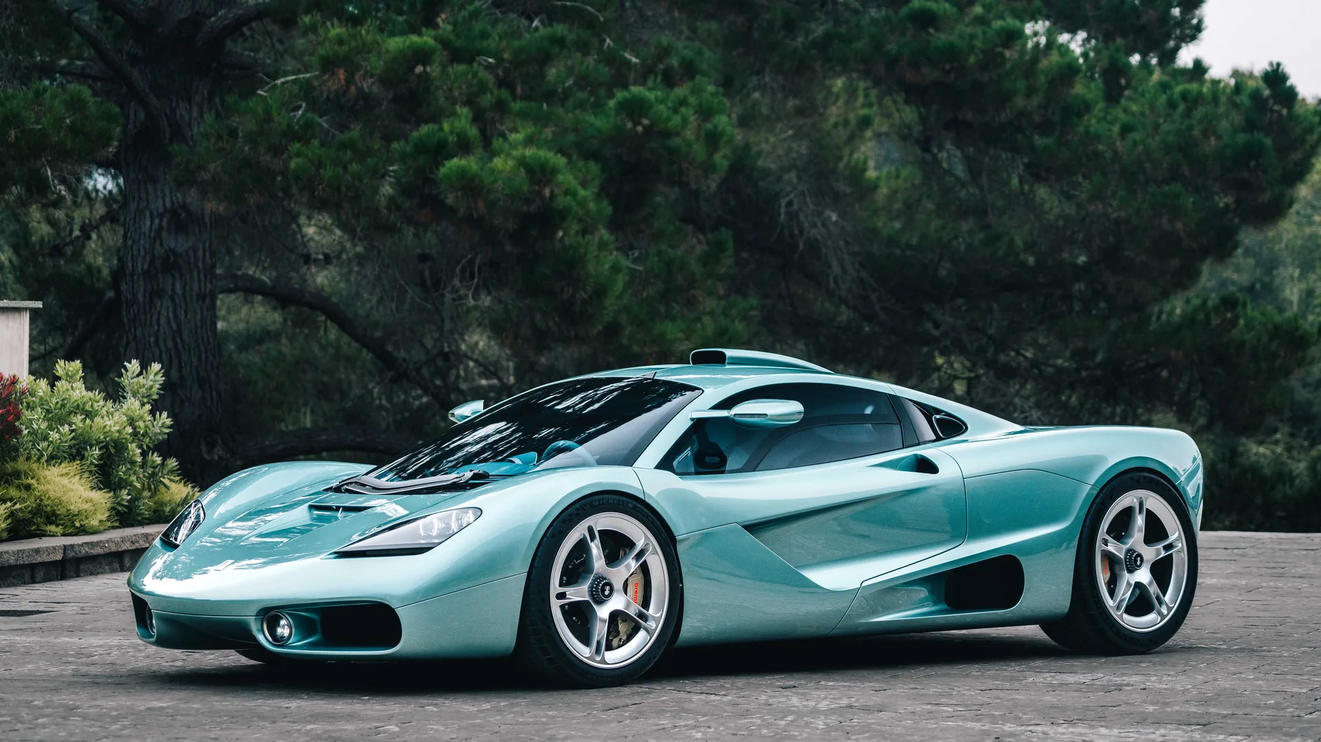 Gordon Murray S1 hero view at The Quail 2026 debut, black and gold naturally aspirated V12 supercar with McLaren F1-inspired proportions