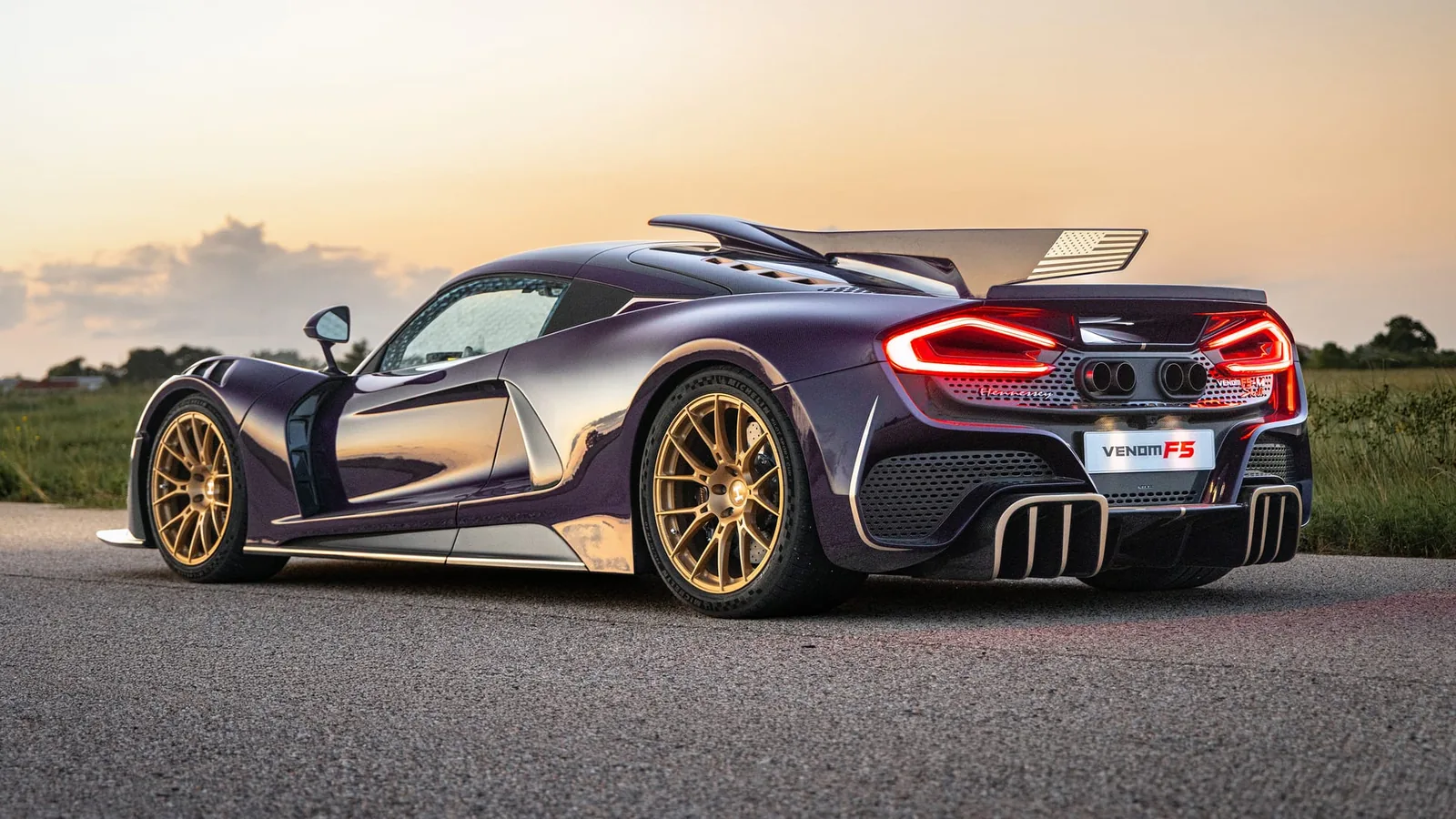 Hennessey Venom F5-M rear three-quarter — dorsal fin trailing edge, exposed carbon fibre and central exhaust tips