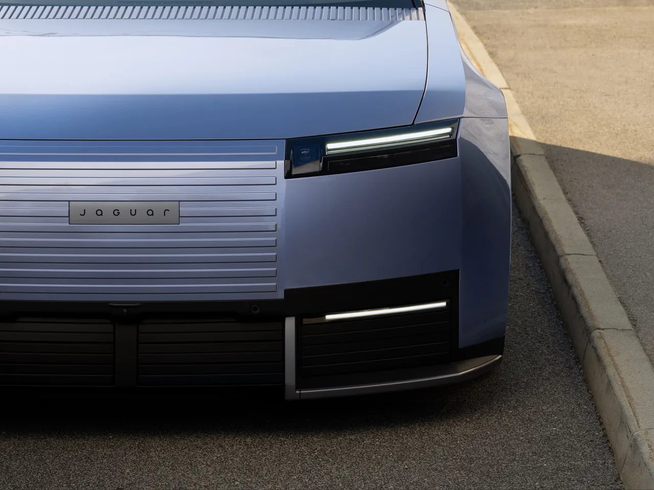 Front of the Jaguar Type 01 with horizontal grille slats, Jaguar wordmark and slim LED headlight