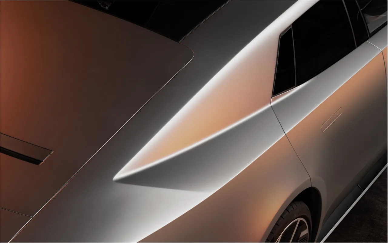 Close-up of the Jaguar Type 01 rear haunch and shoulder line in silver and bronze light