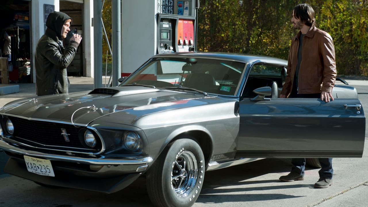 John Wick driving the 1969 Mustang during an action sequence