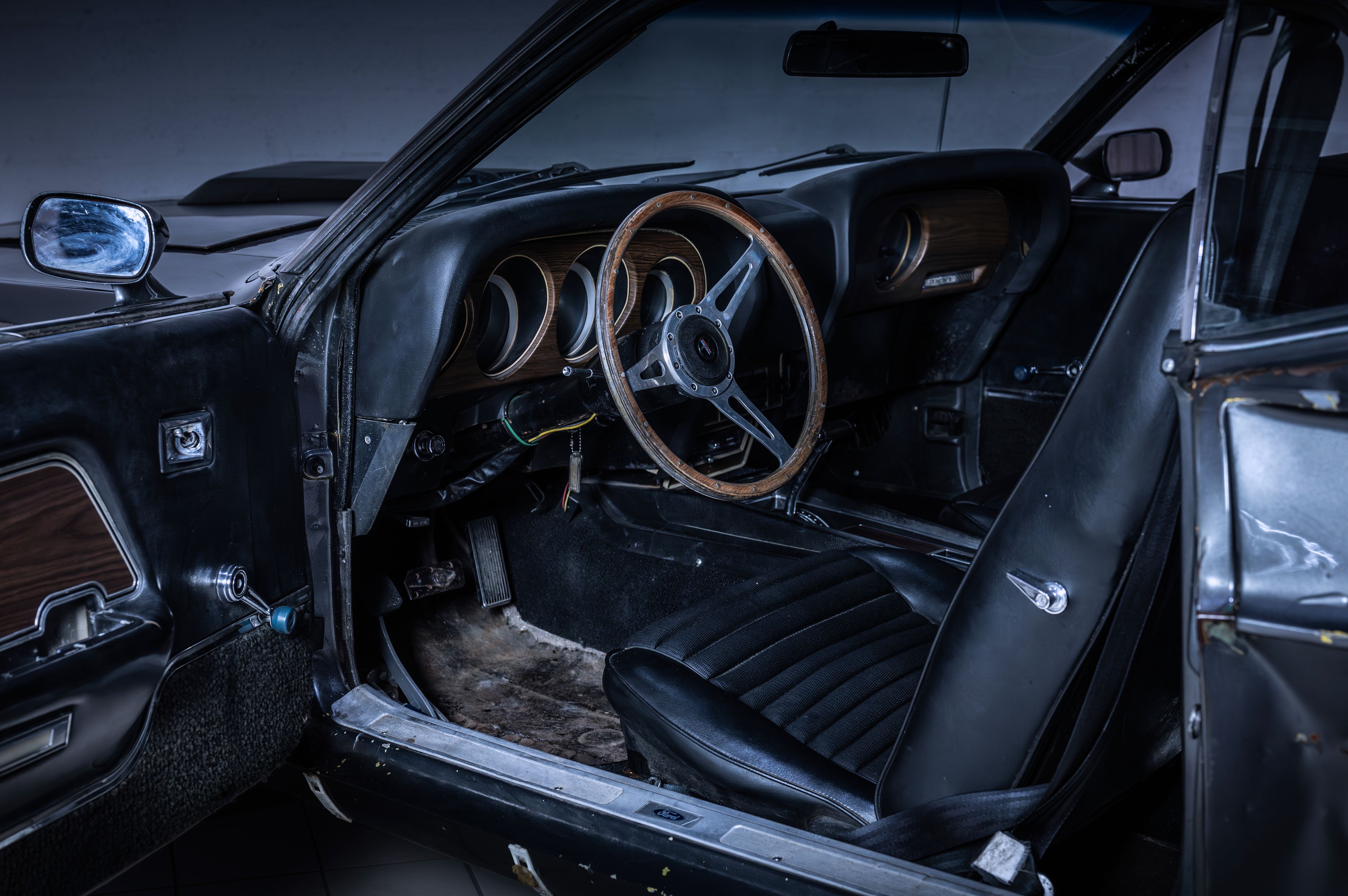 Screen-used 1969 Ford Mustang Mach 1 cabin with wood-rim steering wheel and black seats