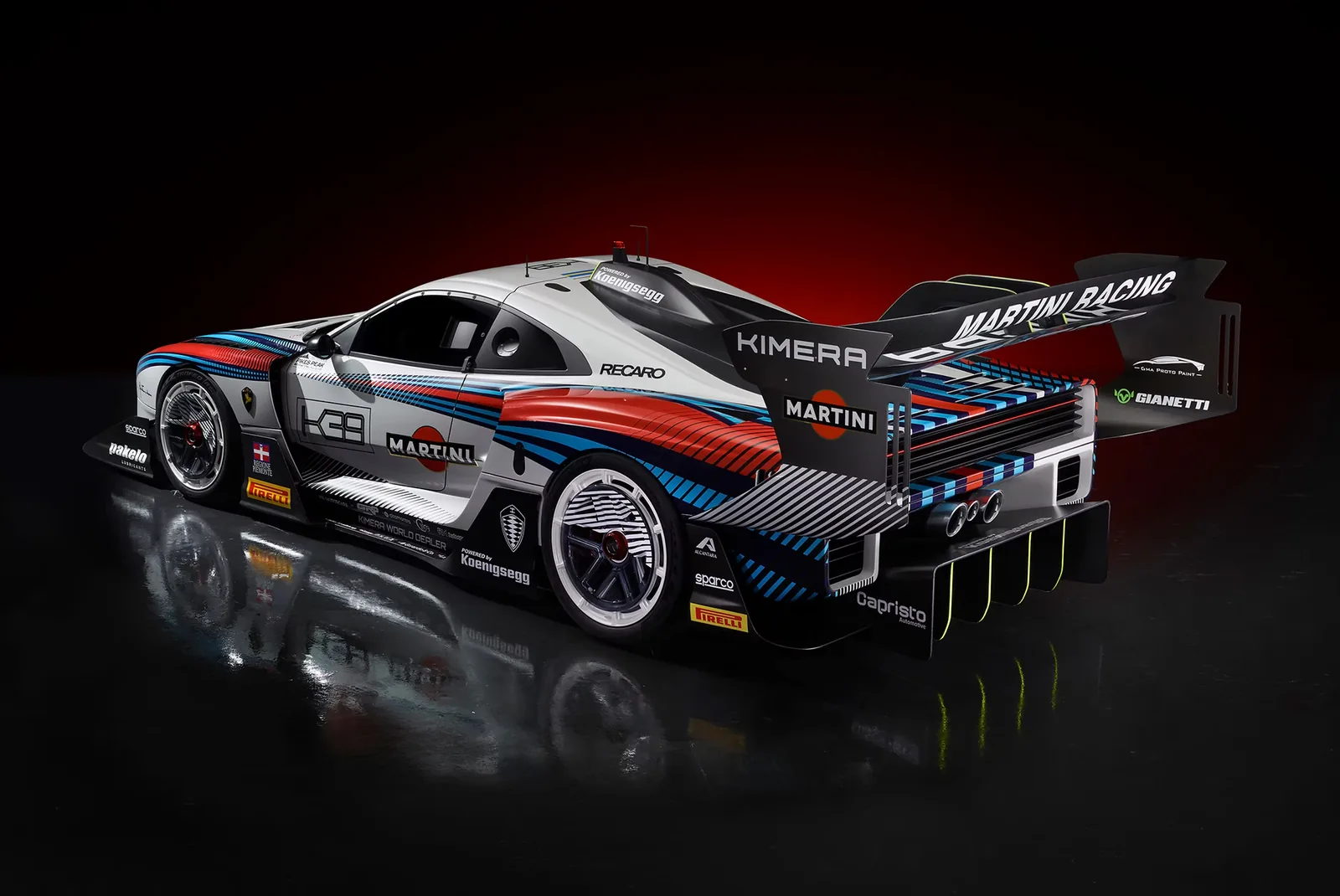 Kimera K-39 Pikes Peak race car in Martini-style livery, rear three-quarter view with large rear wing