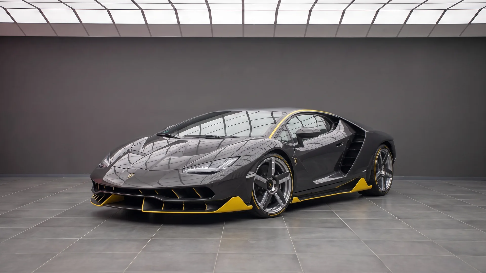Lamborghini Centenario LP 770-4 front three-quarter in exposed carbon fibre with yellow accents — 770 hp naturally aspirated V12, only 40 cars built