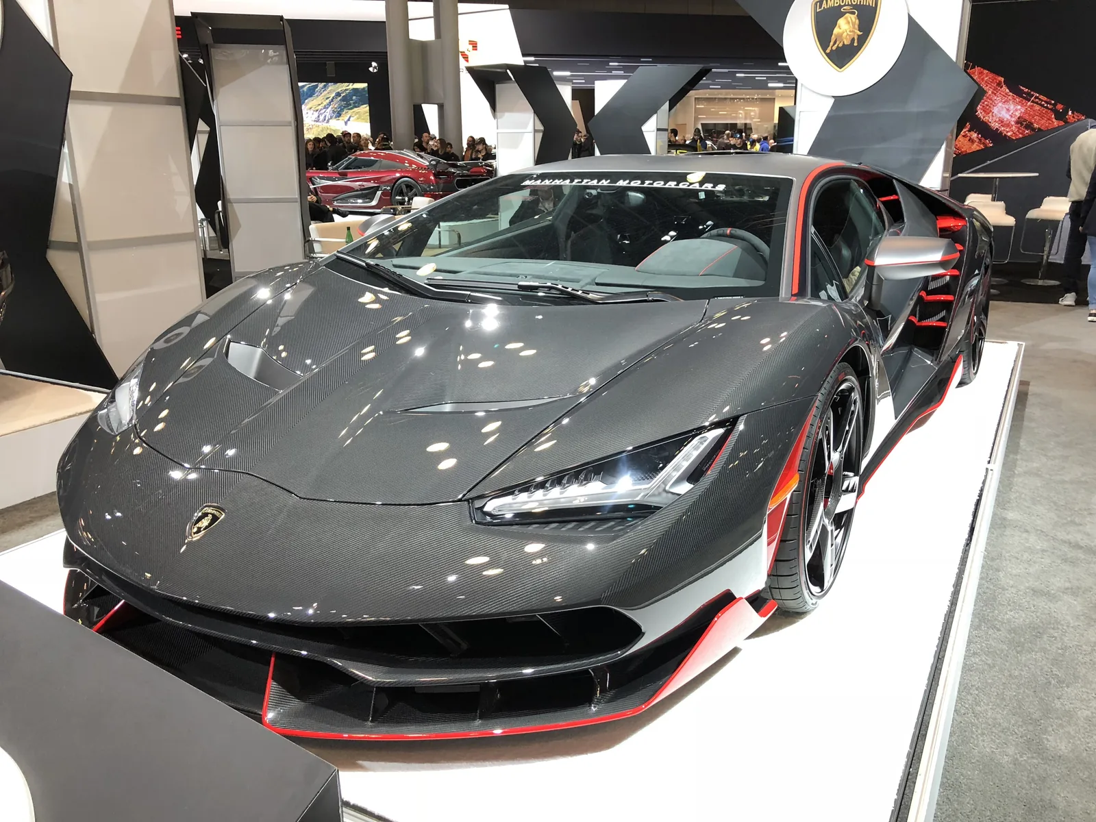 Lamborghini Centenario front end detail at the New York International Auto Show, showing carbon fibre bodywork and red accents