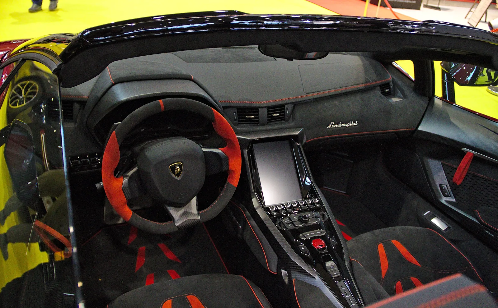 Lamborghini Centenario Roadster cockpit with red leather trim, exposed carbon fibre tub and open roof