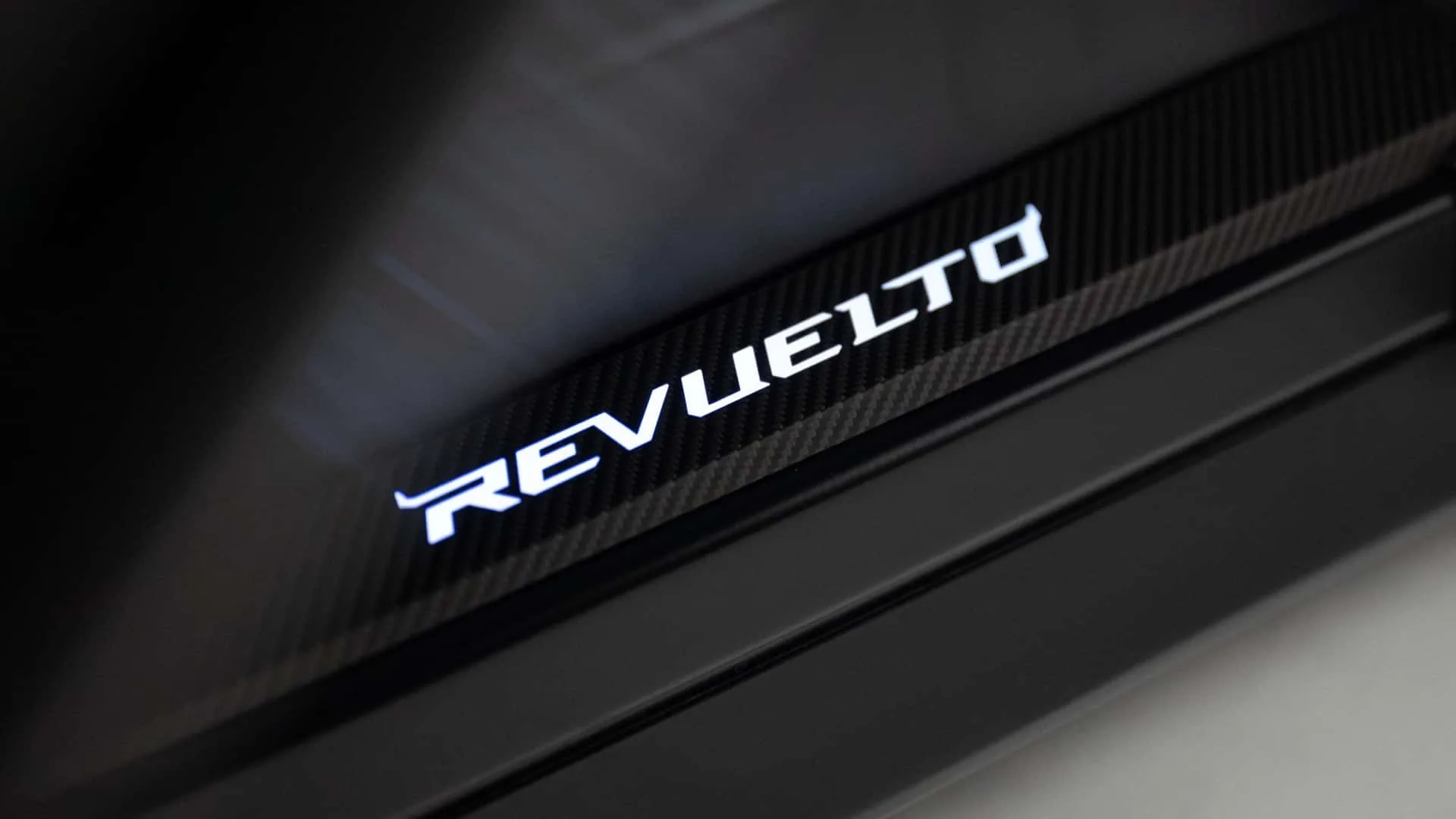 Lamborghini Revuelto SV illuminated door sill with backlit REVUELTO script on carbon fibre