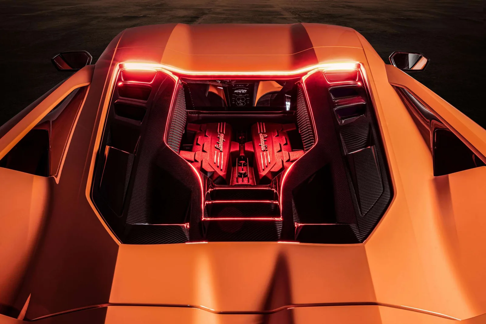 Lamborghini Revuelto exposed V12 engine bay under transparent glass hood