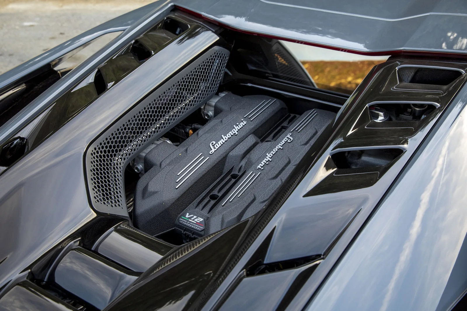 Lamborghini Revuelto rear three-quarter — hexagonal exhaust tips and hybrid V12 architecture