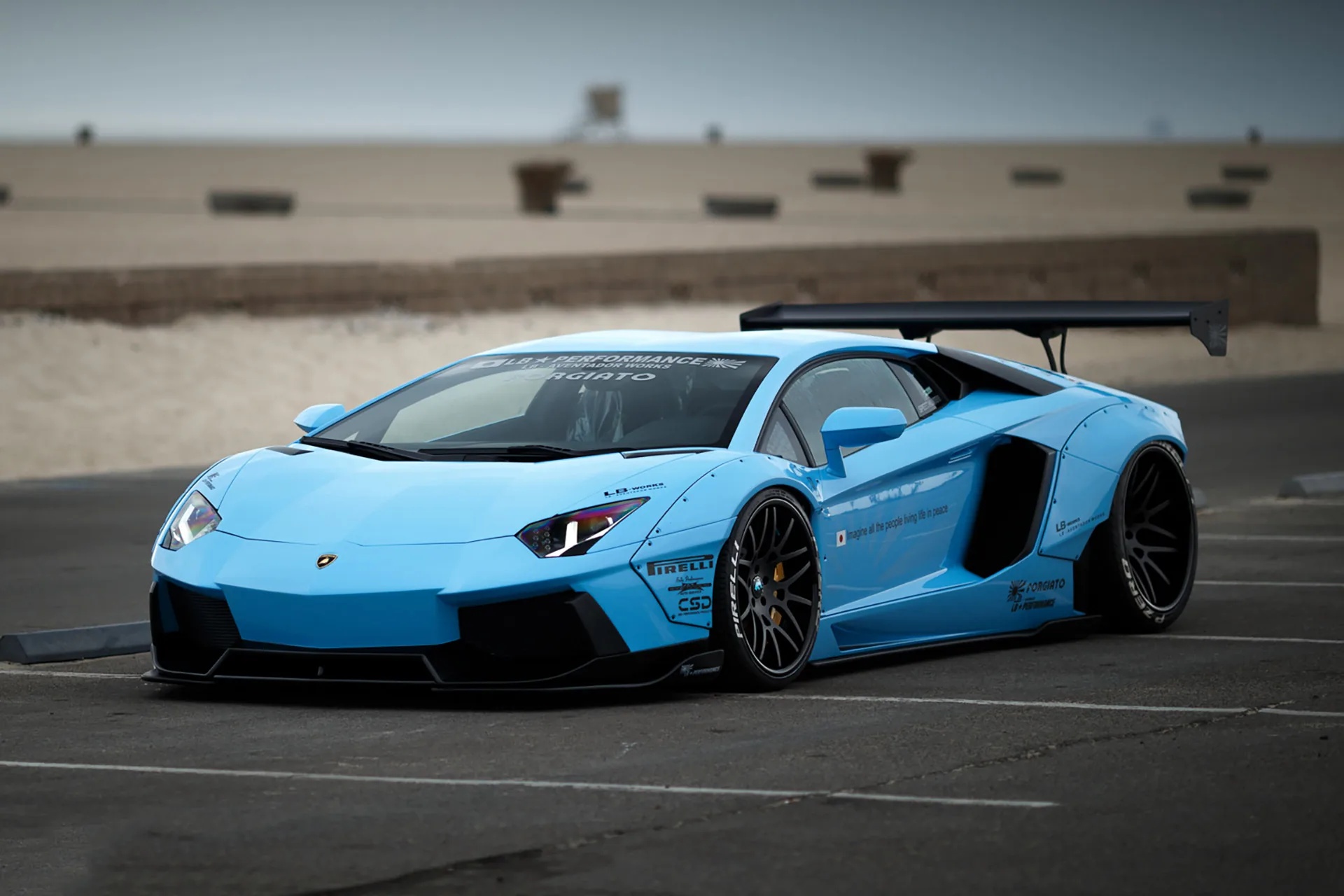 Liberty Walk LB-Works Lamborghini Aventador in light blue with wide fender flares, low stance and a swan-neck GT wing