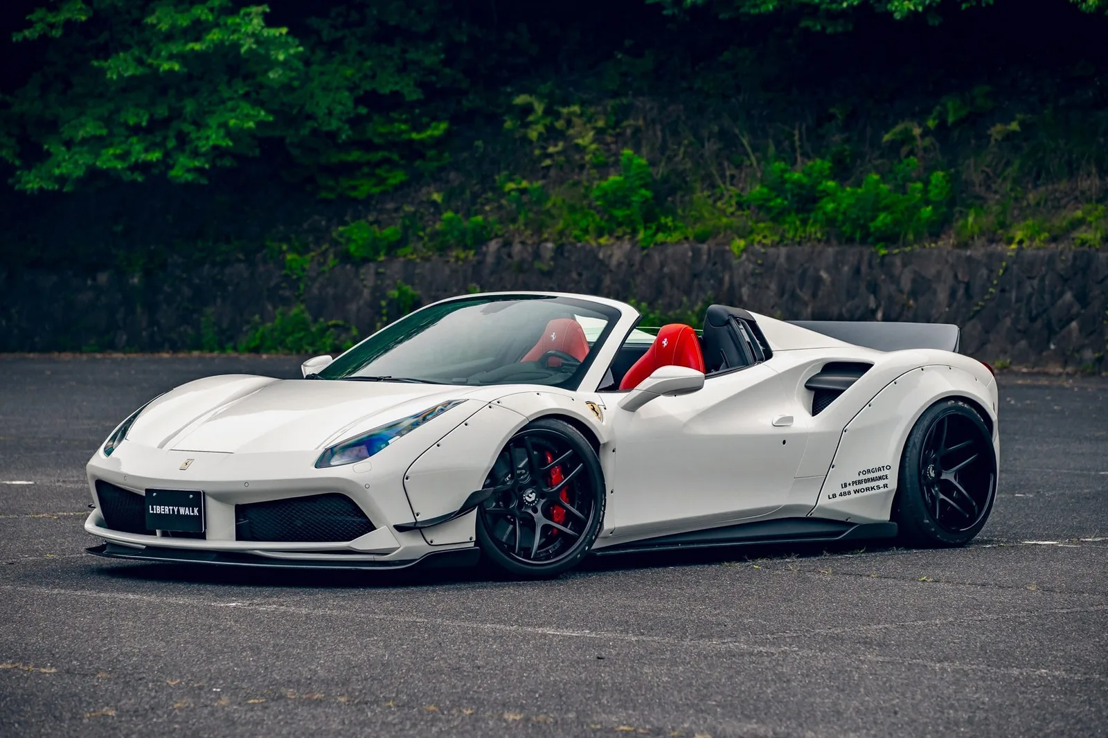 Liberty Walk LB-Works Ferrari 488 Spider in white with wide fenders, forged wheels and the roof down