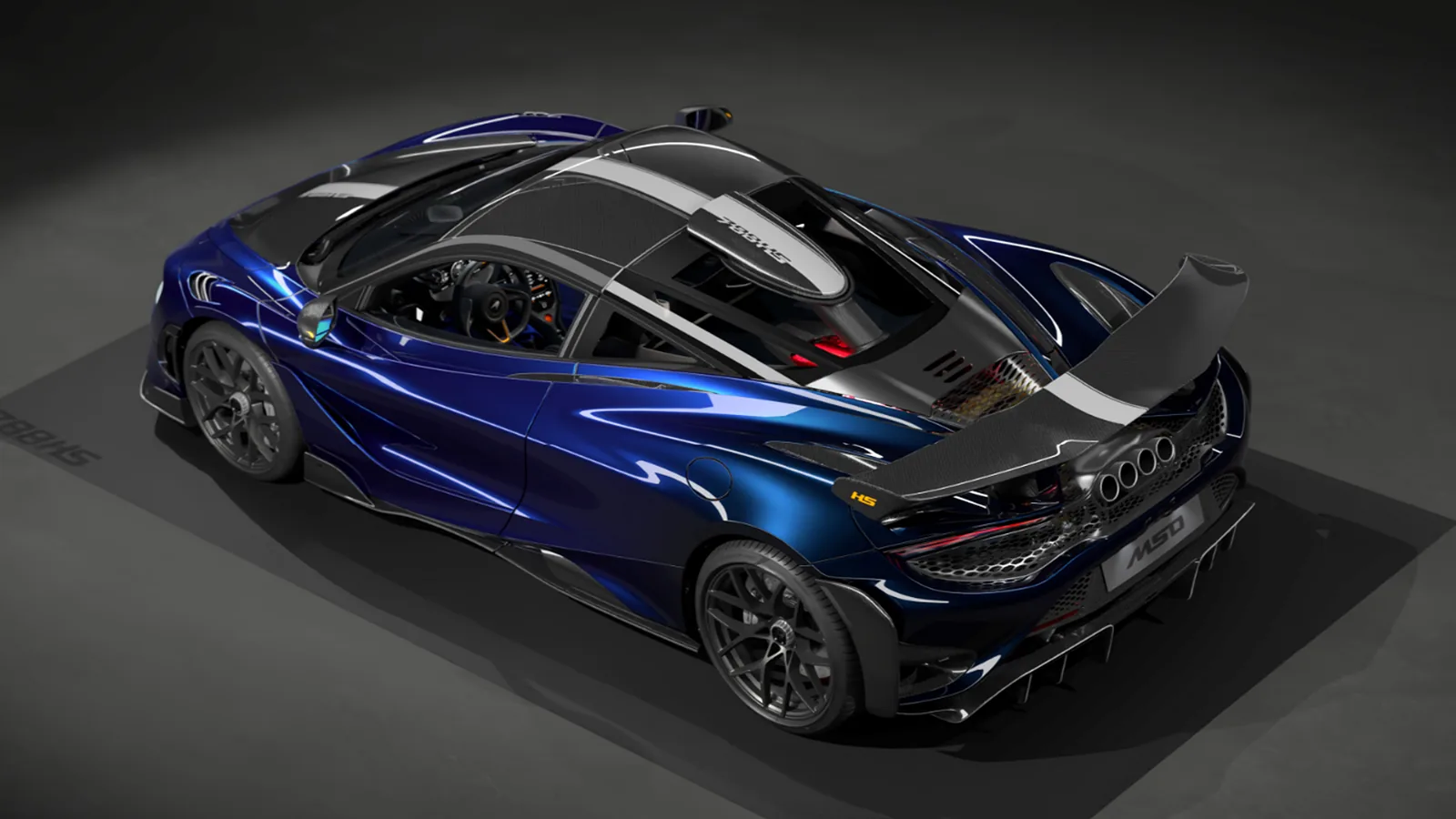 McLaren 788HS rear wing detail showing snowboard-sized carbon element and quad-exhaust finishers