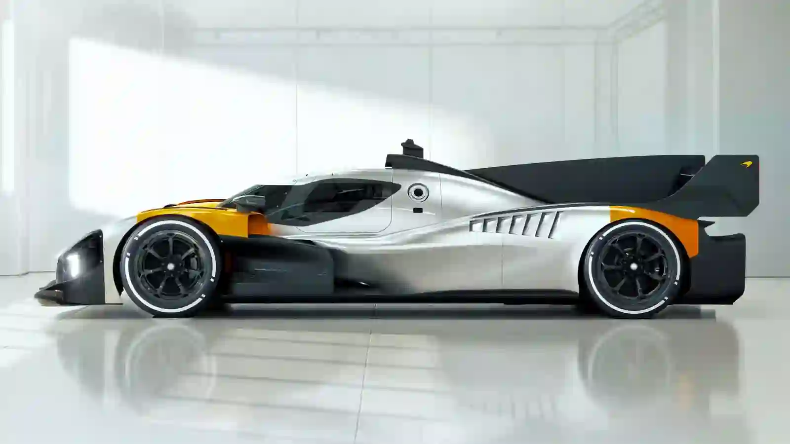 McLaren MCL-HY front view — LMDh aero front splitter, headlight signature and orange M6A-inspired test livery