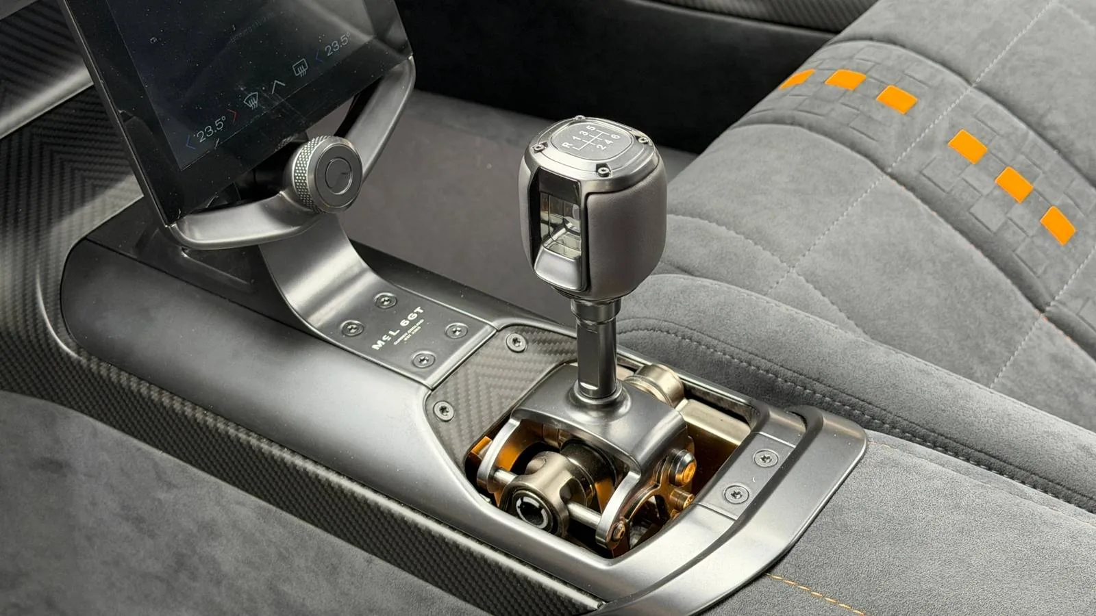 McLaren McL 6GT cabin detail with knurled aluminium controls and driver-facing digital display