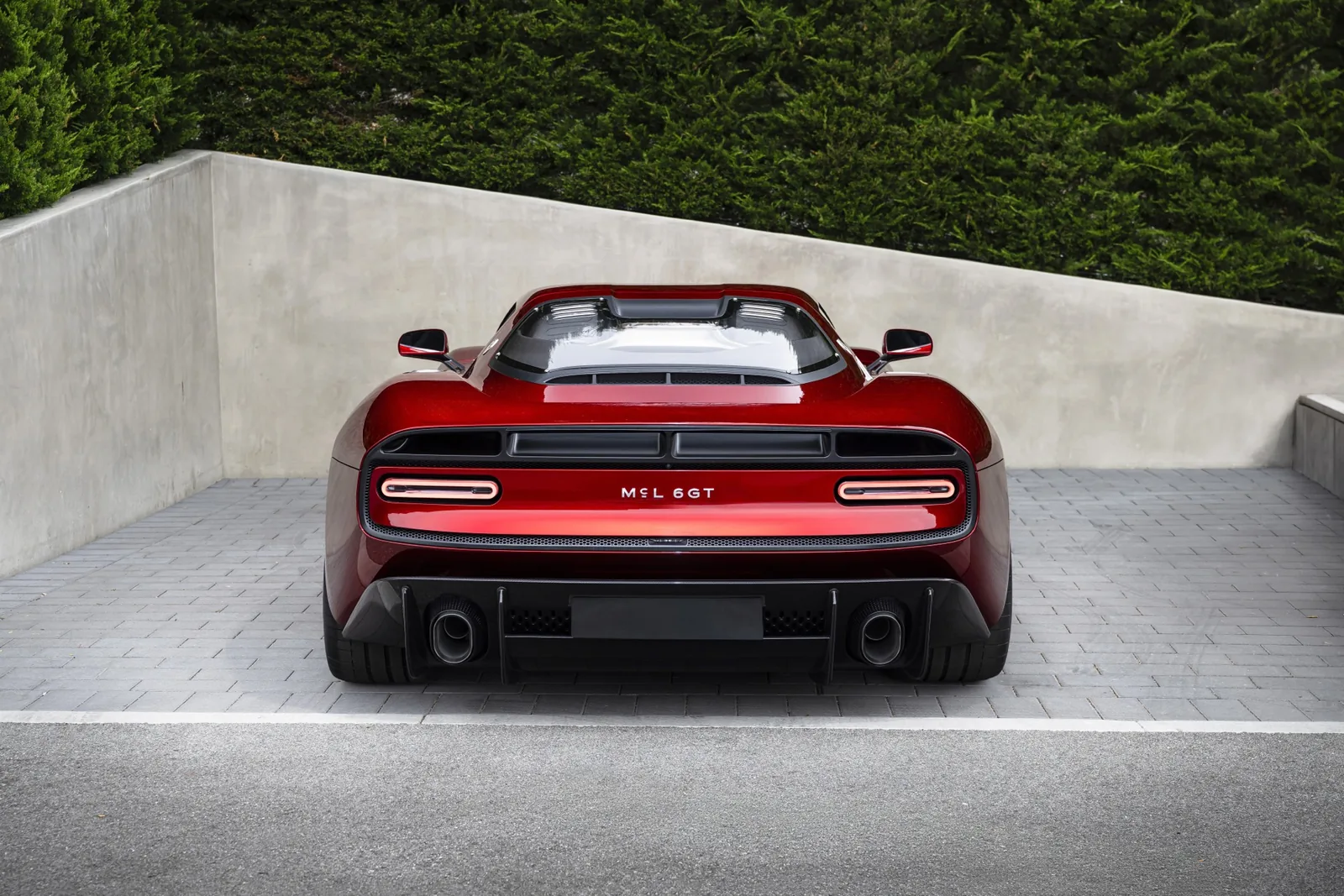 McLaren McL 6GT rear three-quarter view with quad exhaust outlets and carbon rear diffuser