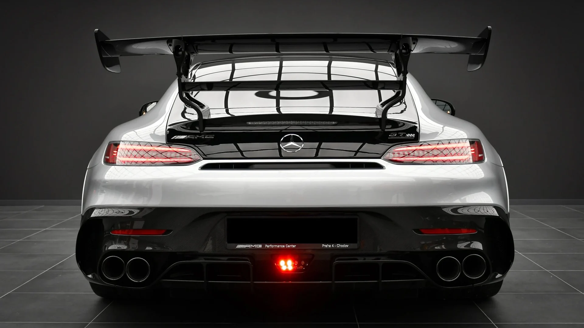 Silver Mercedes-AMG GT Black Series from the rear in the Batman Garage studio, swan-neck wing and quad exhaust