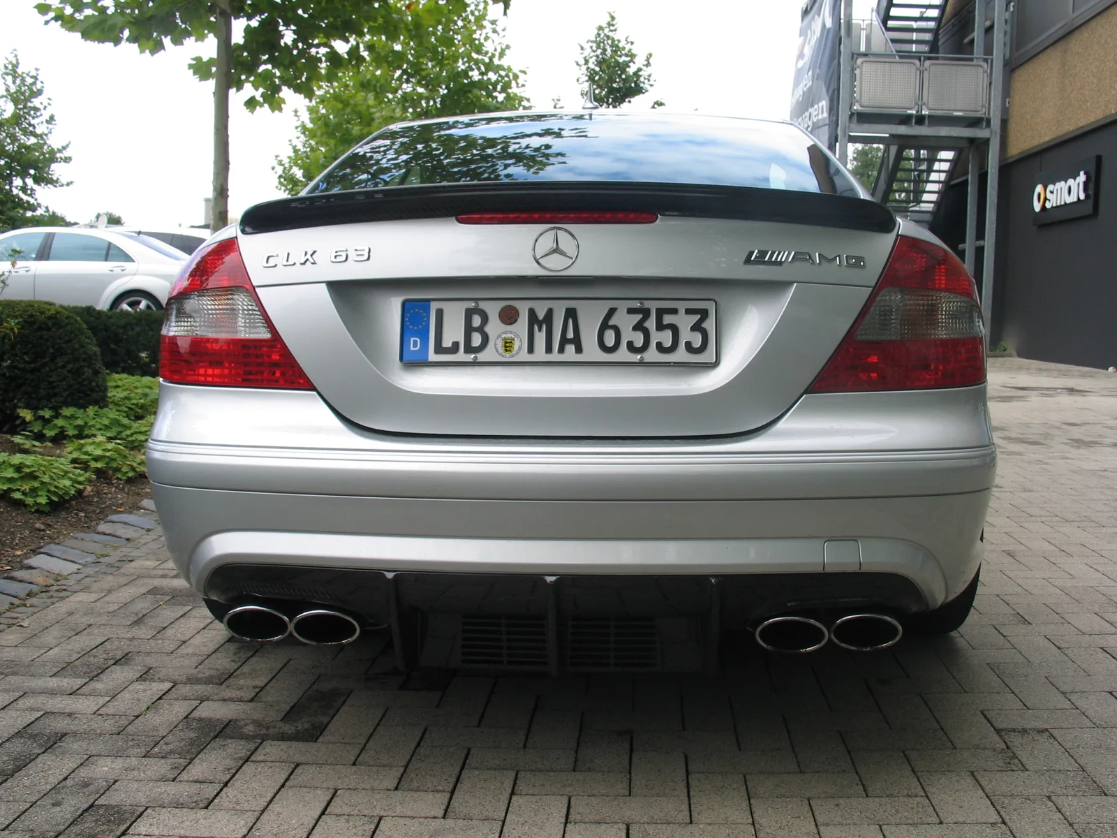 Rear view of a silver Mercedes-Benz CLK 63 AMG Black Series showing quad exhaust tips and carbon rear diffuser