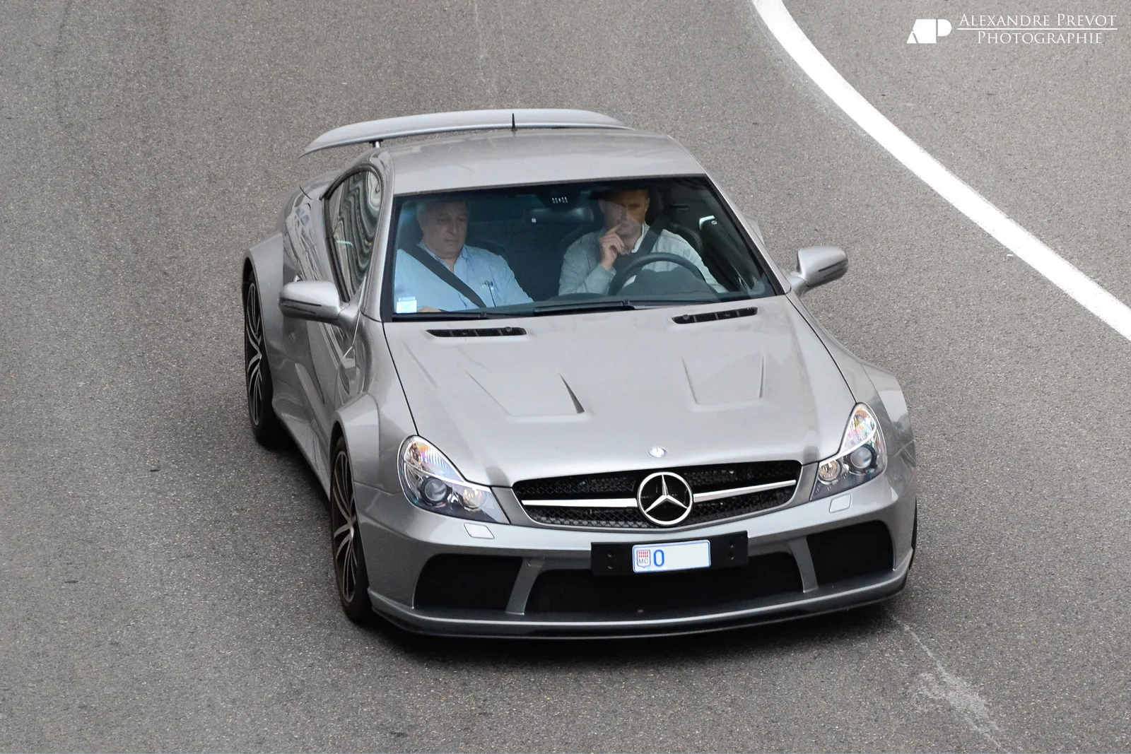 Silver Mercedes-Benz SL 65 AMG Black Series driving on a track curve, overhead front view