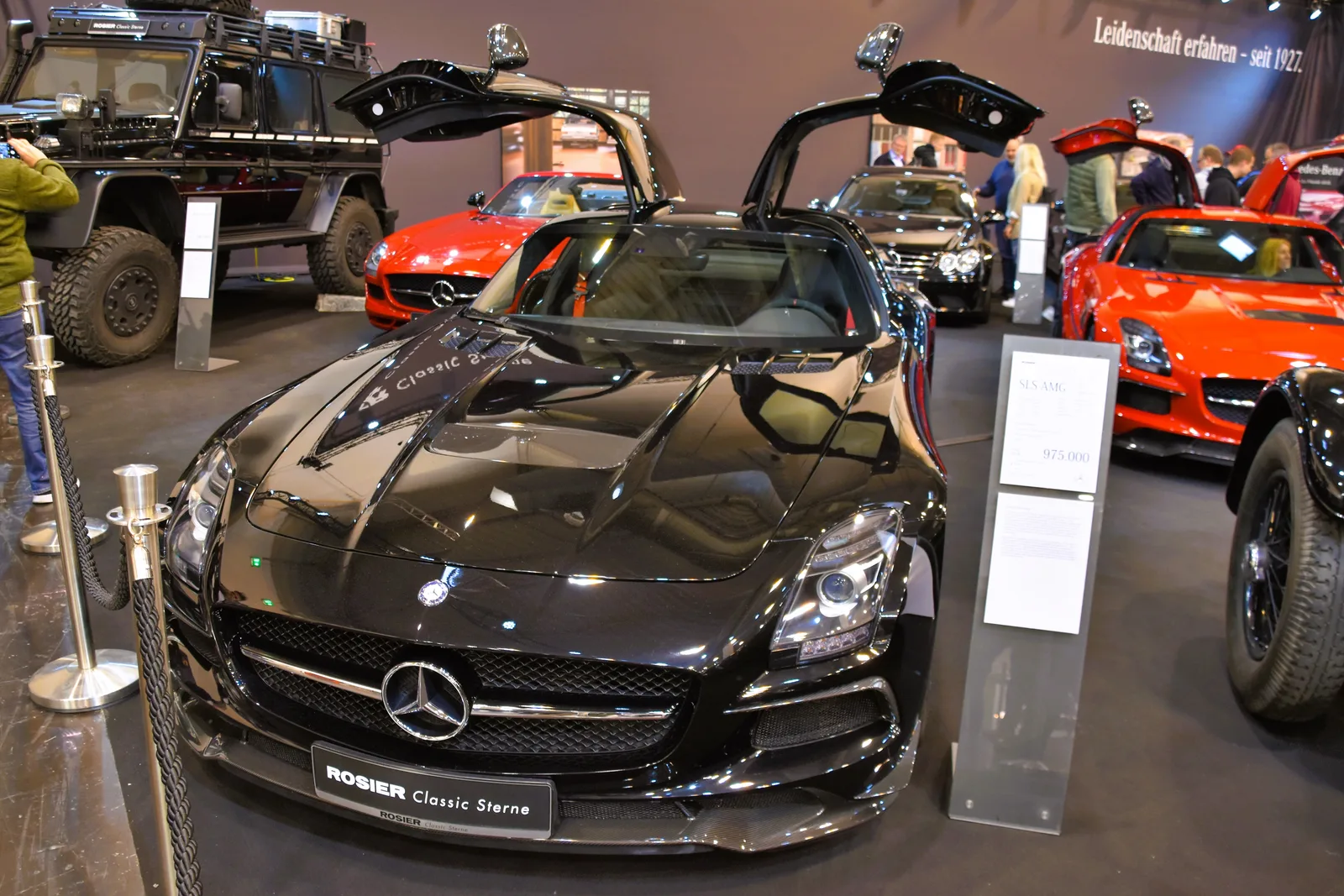 Black Mercedes-Benz SLS AMG Black Series with gullwing doors open, displayed indoors