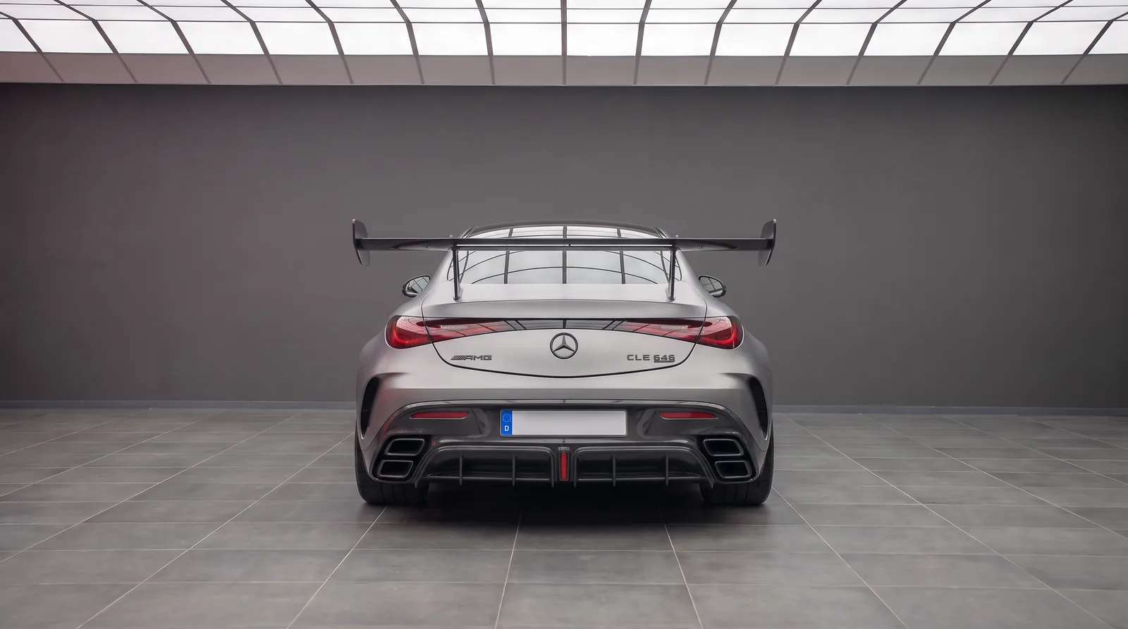 Mercedes-AMG CLE 646 Mythos rear head-on studio view with fixed carbon rear wing, quad exhaust outlets and diffuser