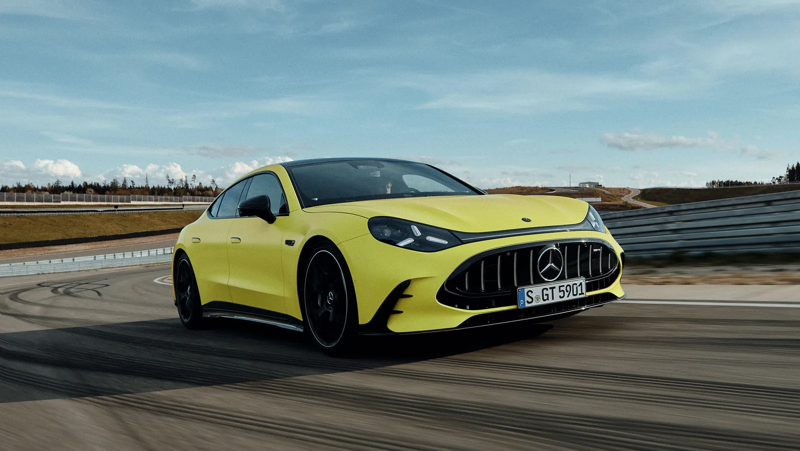 2027 Mercedes-AMG GT 4-Door Coupé EV front three-quarter view showing the new shield-shaped grille design that observers compared unfavourably to Aston Martin's signature grille and the controversial proportions of the 2500 kg electric four-door