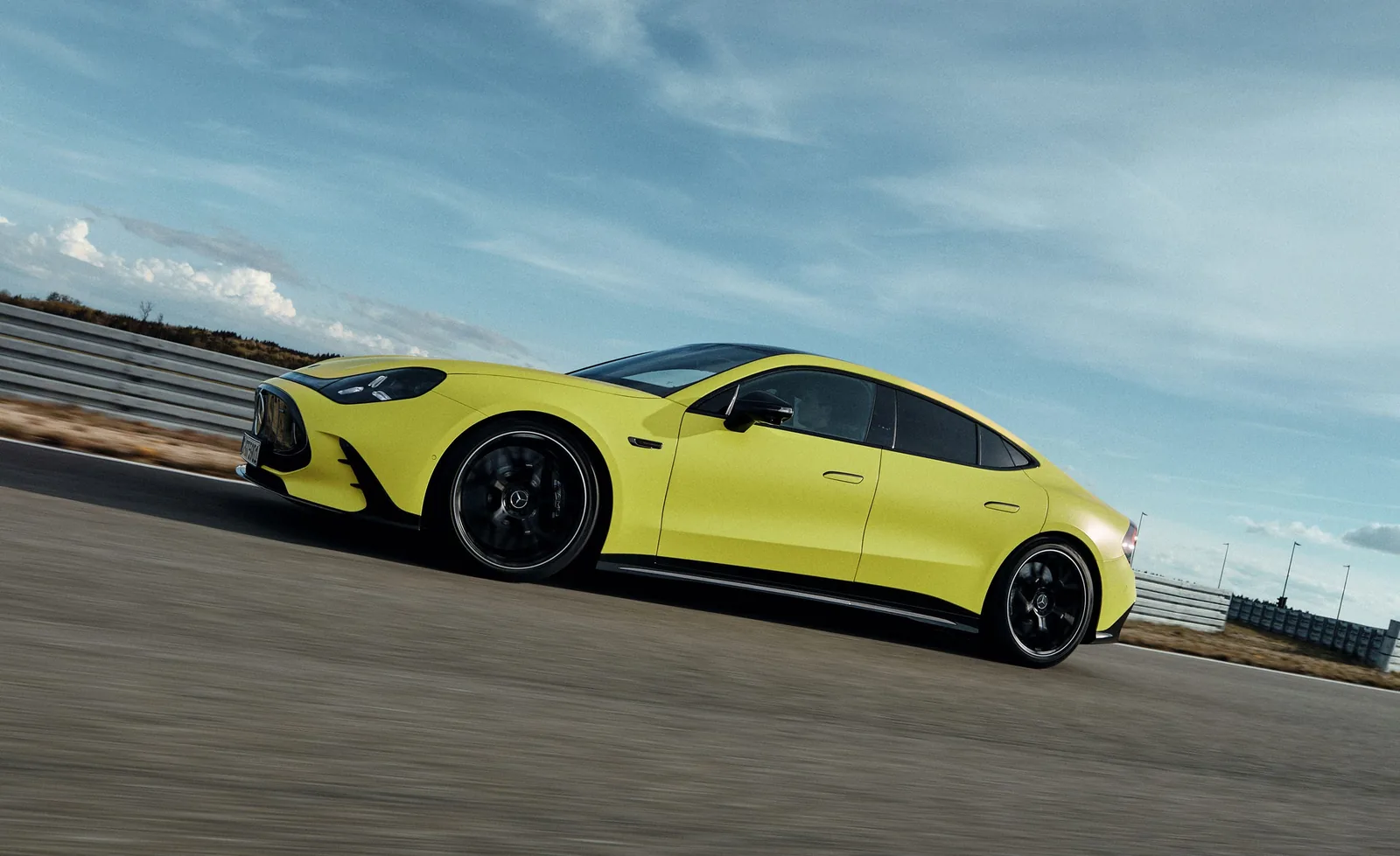 2027 Mercedes-AMG GT 4-Door Coupé EV rear view showing the wide slab-sided rear with full-width LED light strip that drew negative reactions on social media and Reddit threads for lacking the sculpted form of the outgoing combustion model