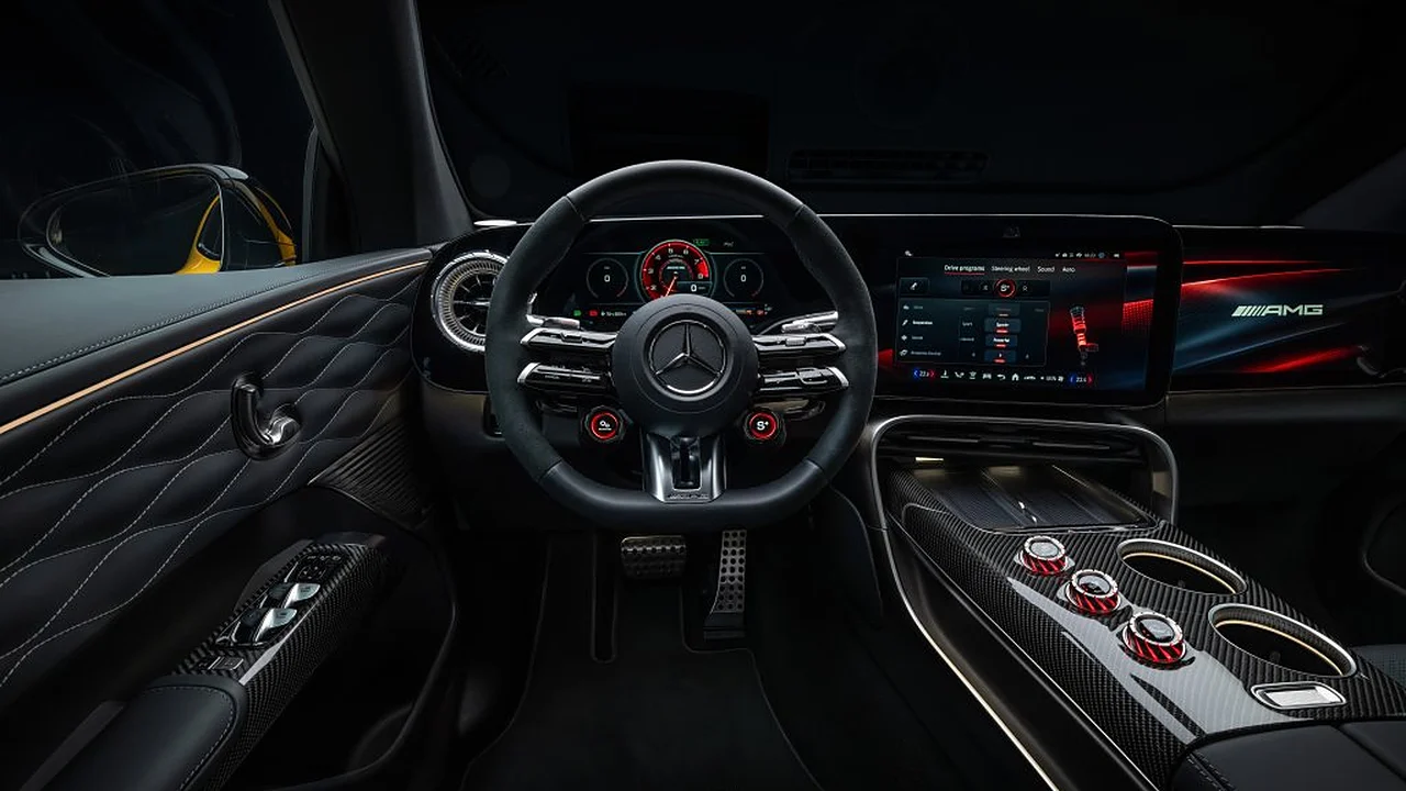 Mercedes-AMG GT SUV cockpit with AMG Performance steering wheel, 10.2-inch driver display, 14-inch touchscreen and three red AMG Race Engineer dials on the carbon centre console