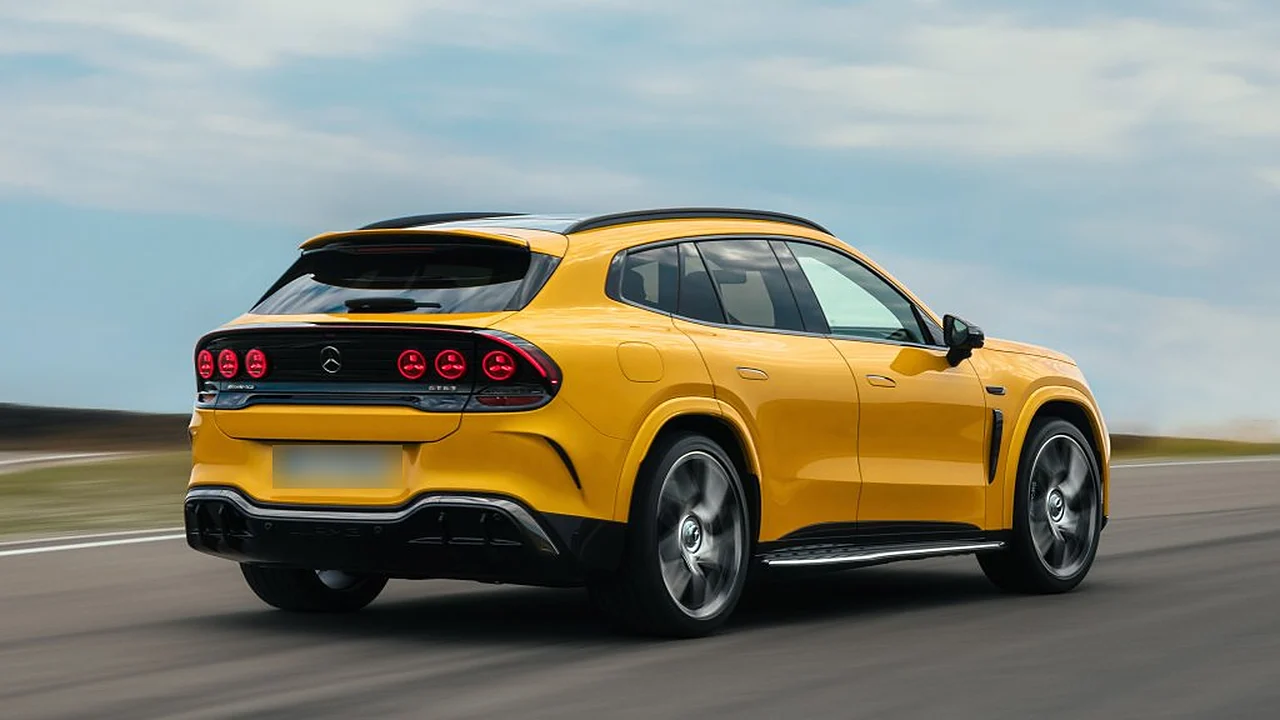 Yellow Mercedes-AMG GT SUV rear three-quarter view at speed, with six round red tail lights and a sloping roofline