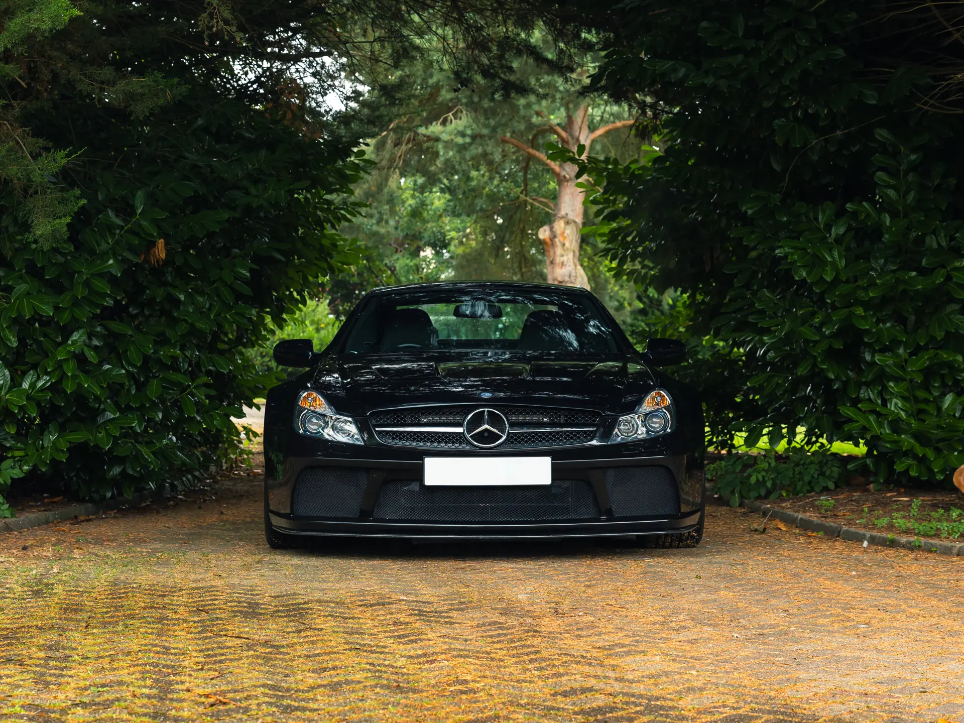 2009 Mercedes SL65 AMG Black Series front head-on — wide carbon splitter, deep intakes, fixed carbon roof