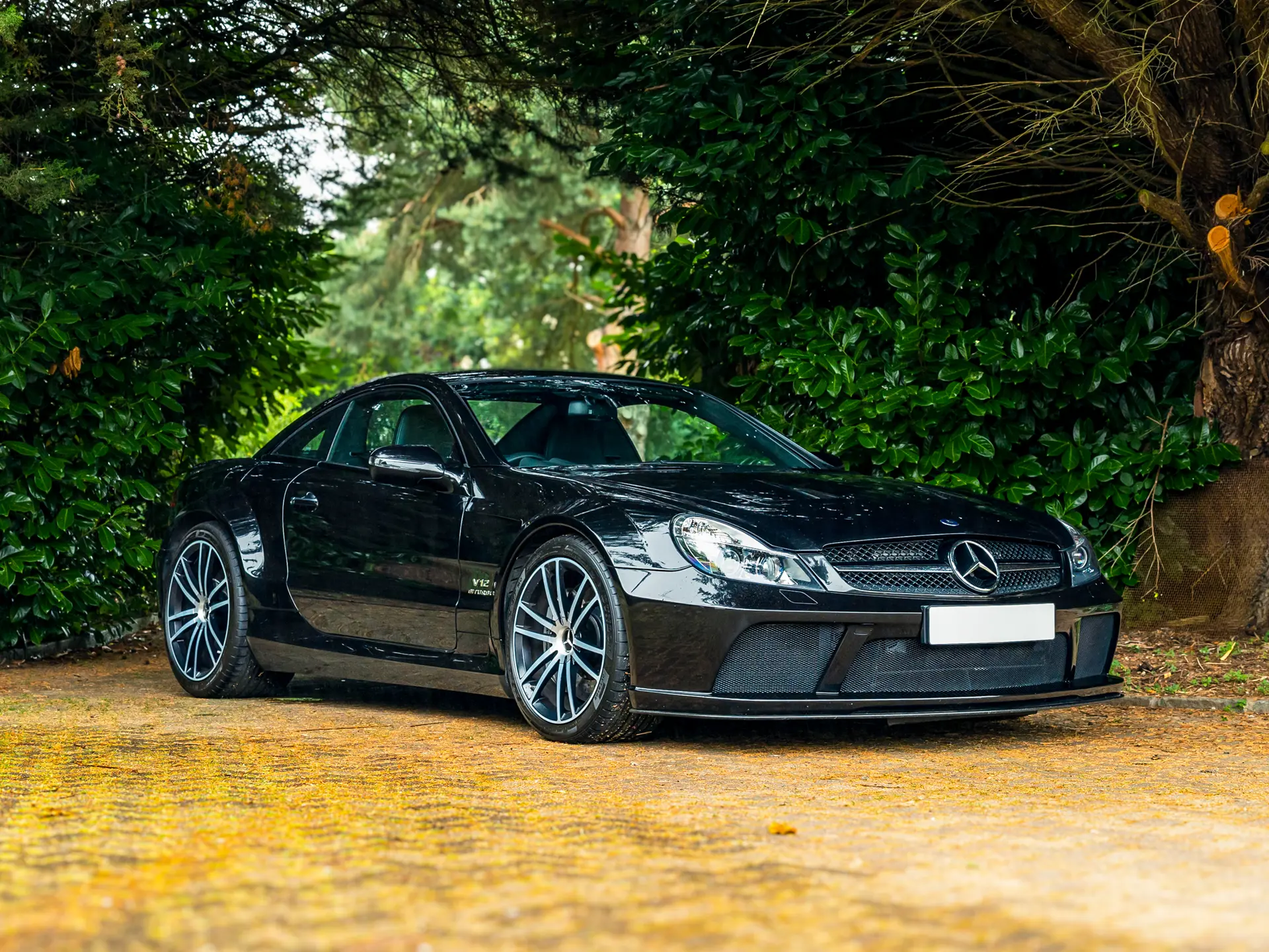 2009 Mercedes SL65 AMG Black Series front three-quarter — black paint, fixed carbon roof, AMG forged wheels