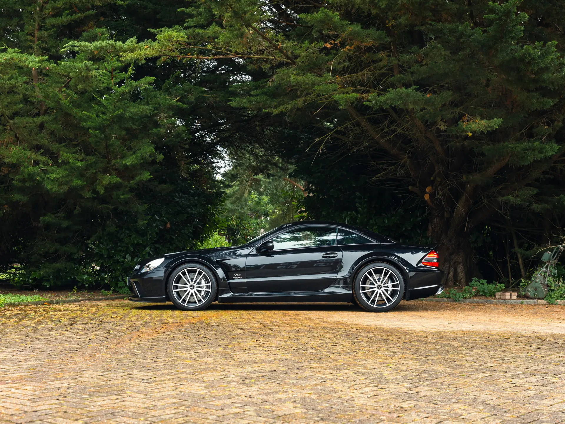 2009 Mercedes SL65 AMG Black Series side profile in black, R230 chassis with widened tracks and AMG 19-inch forged wheels