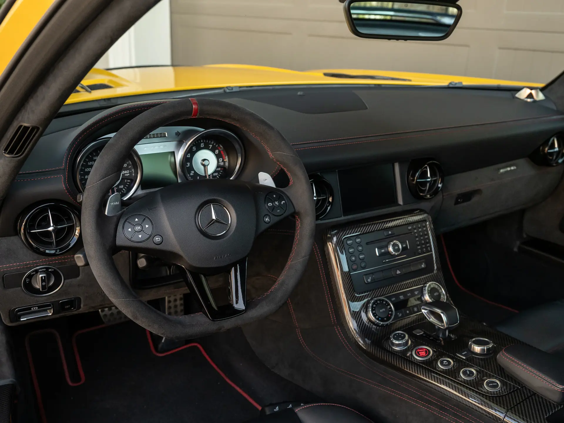 2013 Mercedes SLS AMG Black Series cockpit — AMG performance steering wheel in Alcantara with red stitching, carbon-fibre console