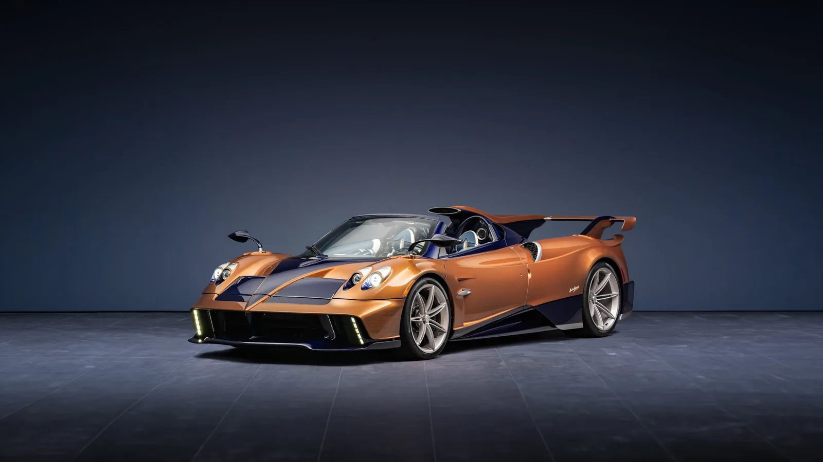 Pagani Huayra 70 Derecho head-on front — twin round headlights, active front splitter and carbon fibre air intakes flanking the Pearl Orange centre bonnet