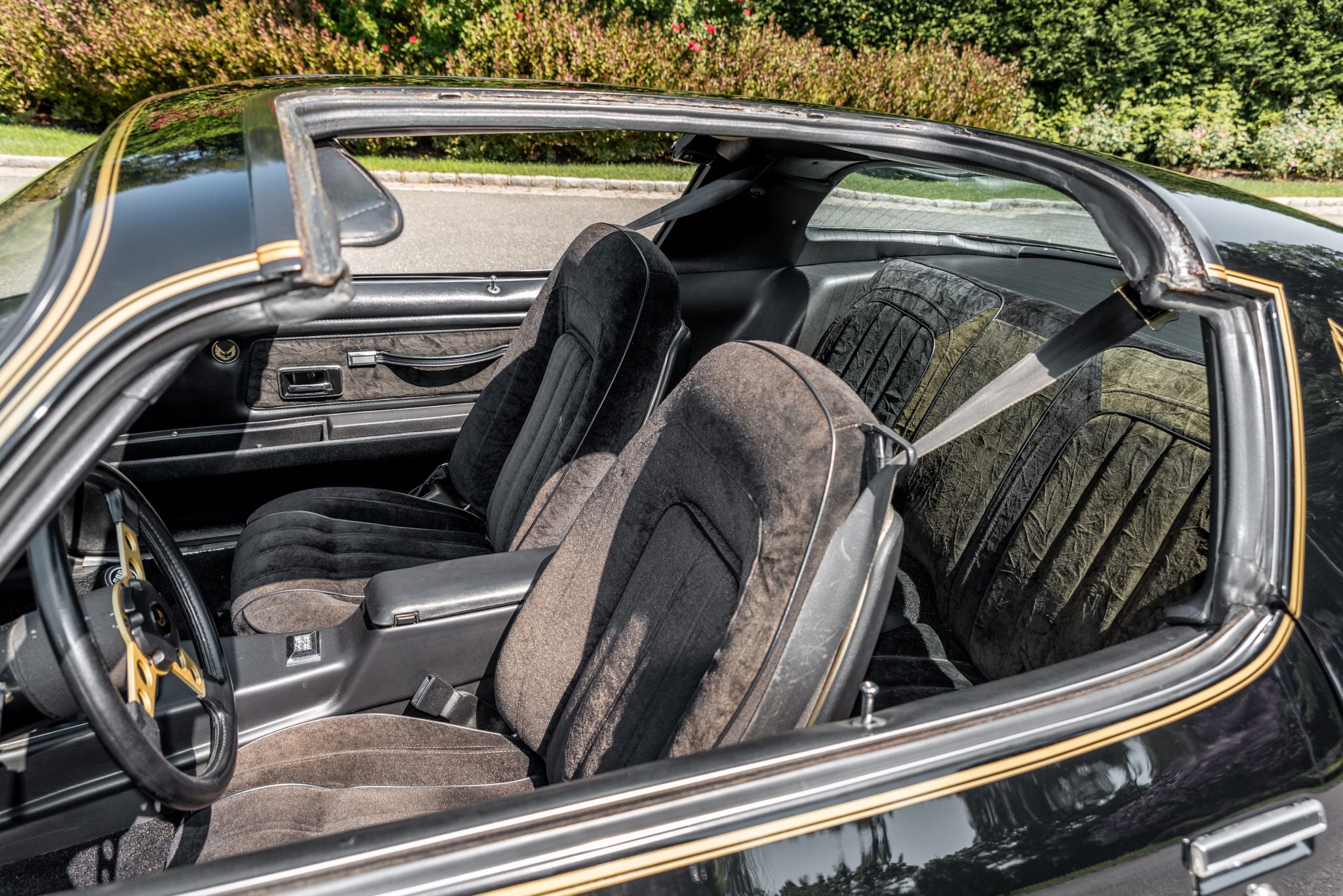 1977 Pontiac Firebird Trans Am black interior viewed through removable T-top roof
